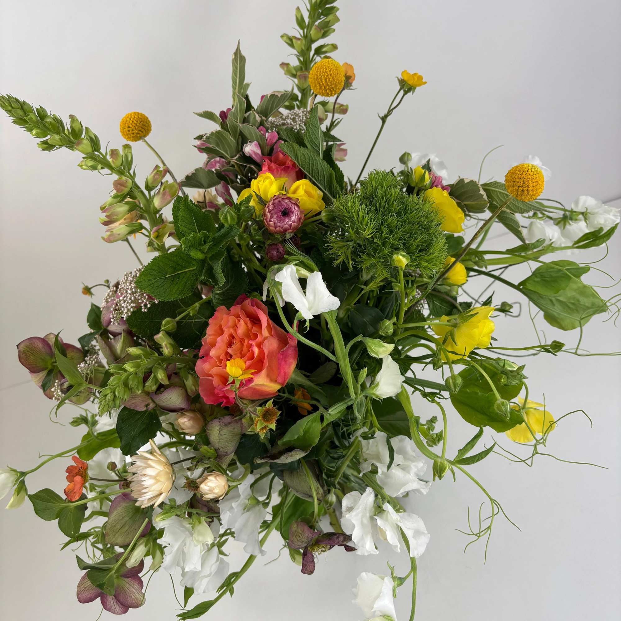 Loose mixed bouquet with yellow, white, pink, and orange flowers