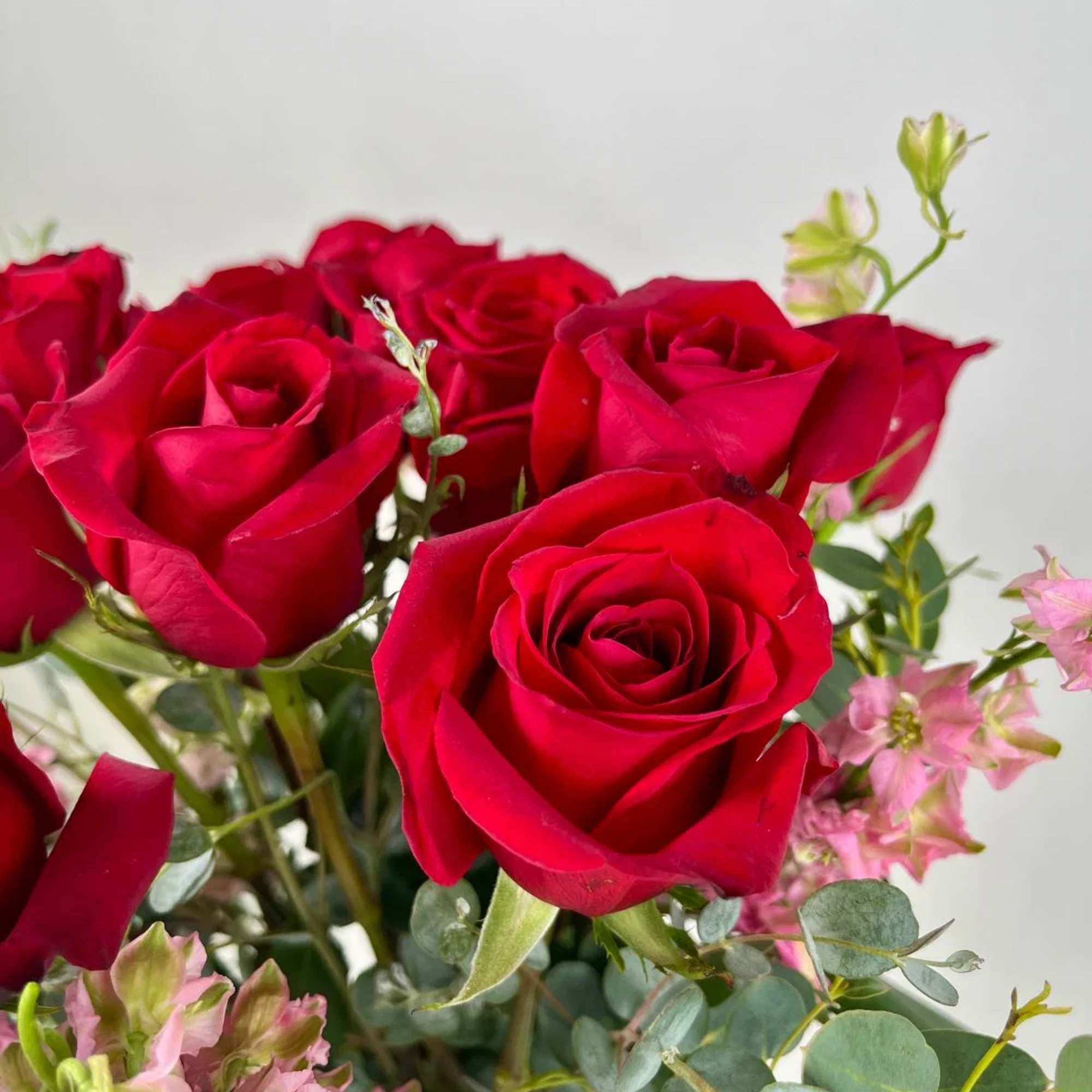 Bouquet of red roses with pink filler flowers and eucalyptus