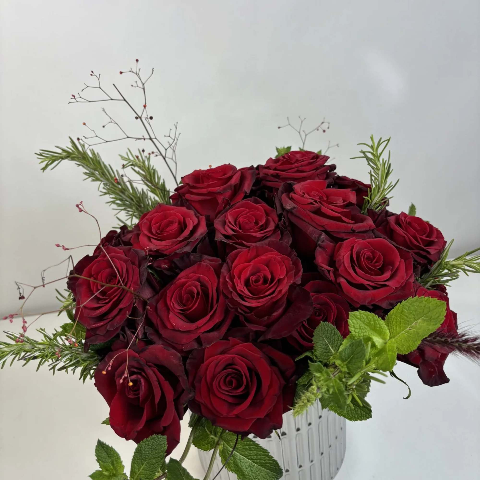 Bouquet of deep red roses in a clear ribbed vase, photo 2 of 4