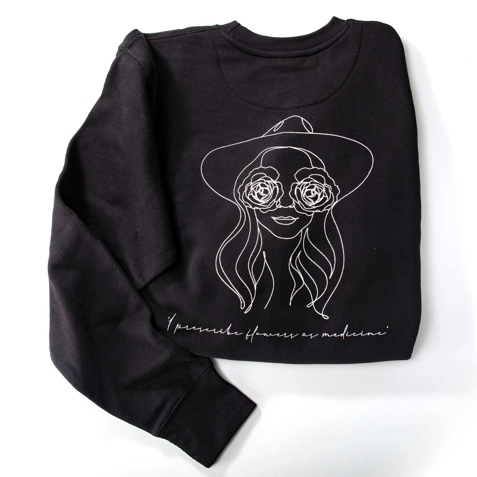 Black sweatshirt with a white line drawing of a woman wearing rose-shaped glasses