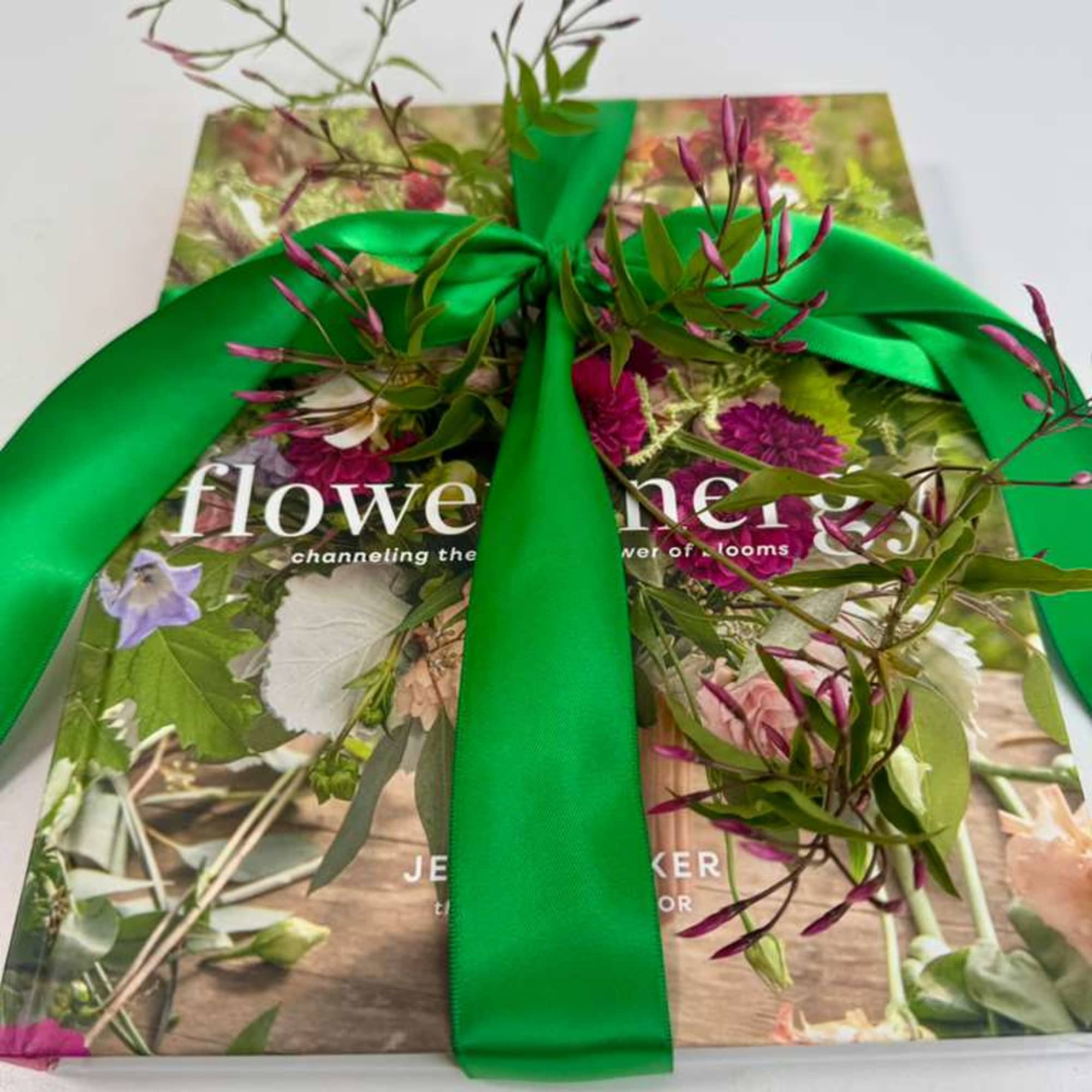 Gift box wrapped with a bright green ribbon and floral print cover
