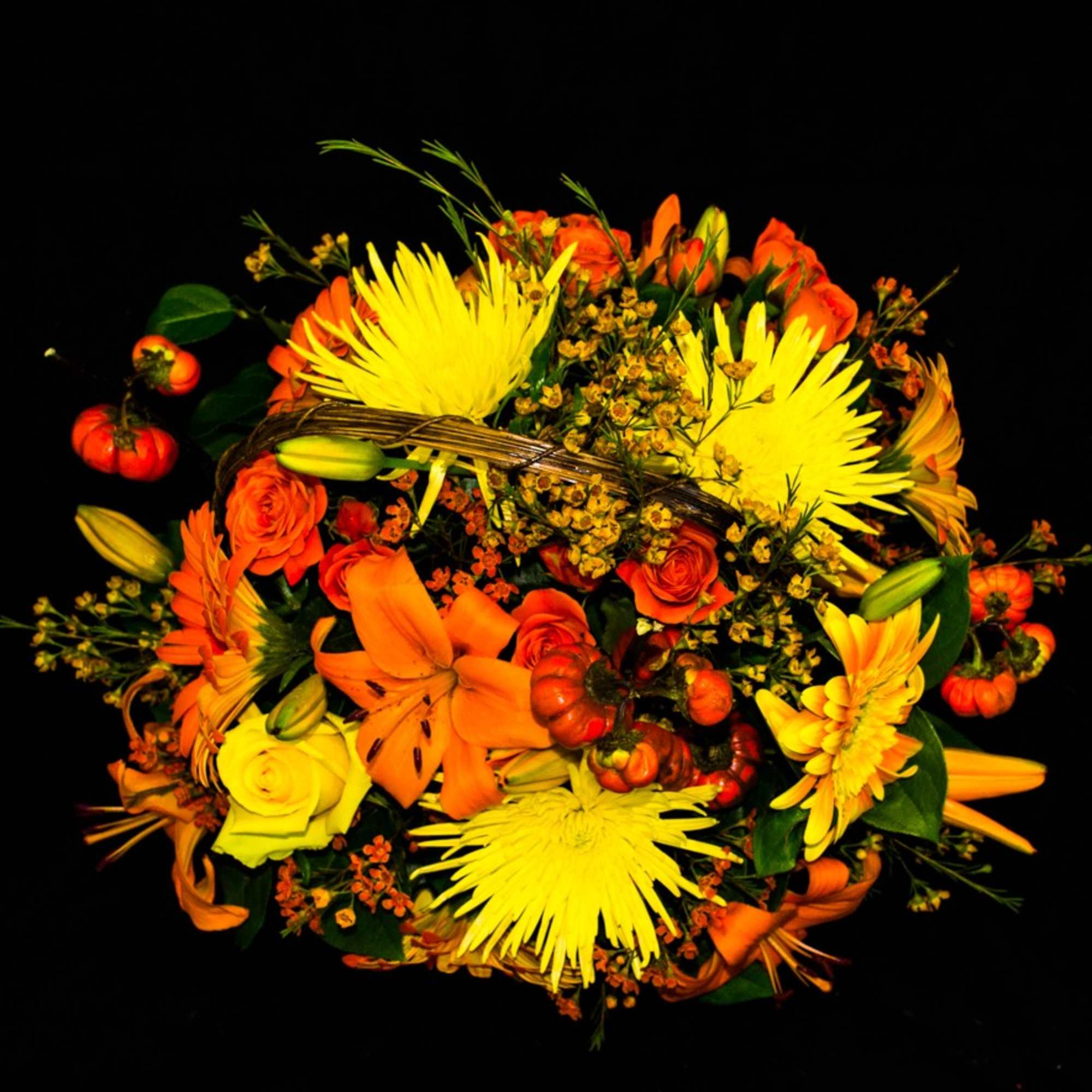 Orange and yellow mixed bouquet with lilies, roses, and spider mums