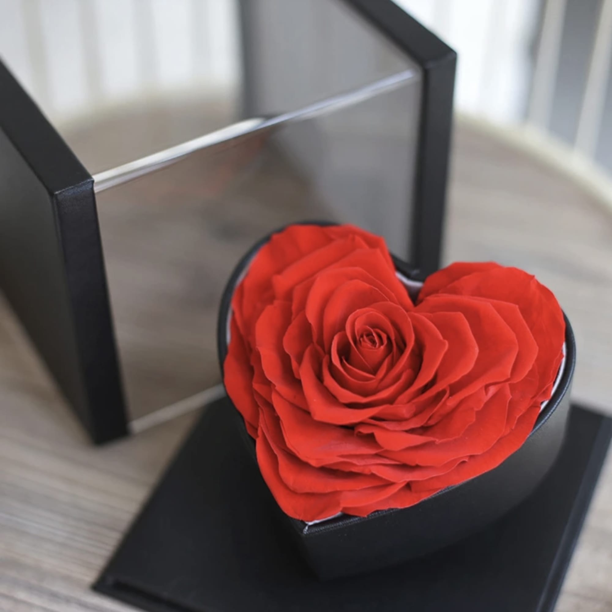 Red rose in a black heart-shaped box