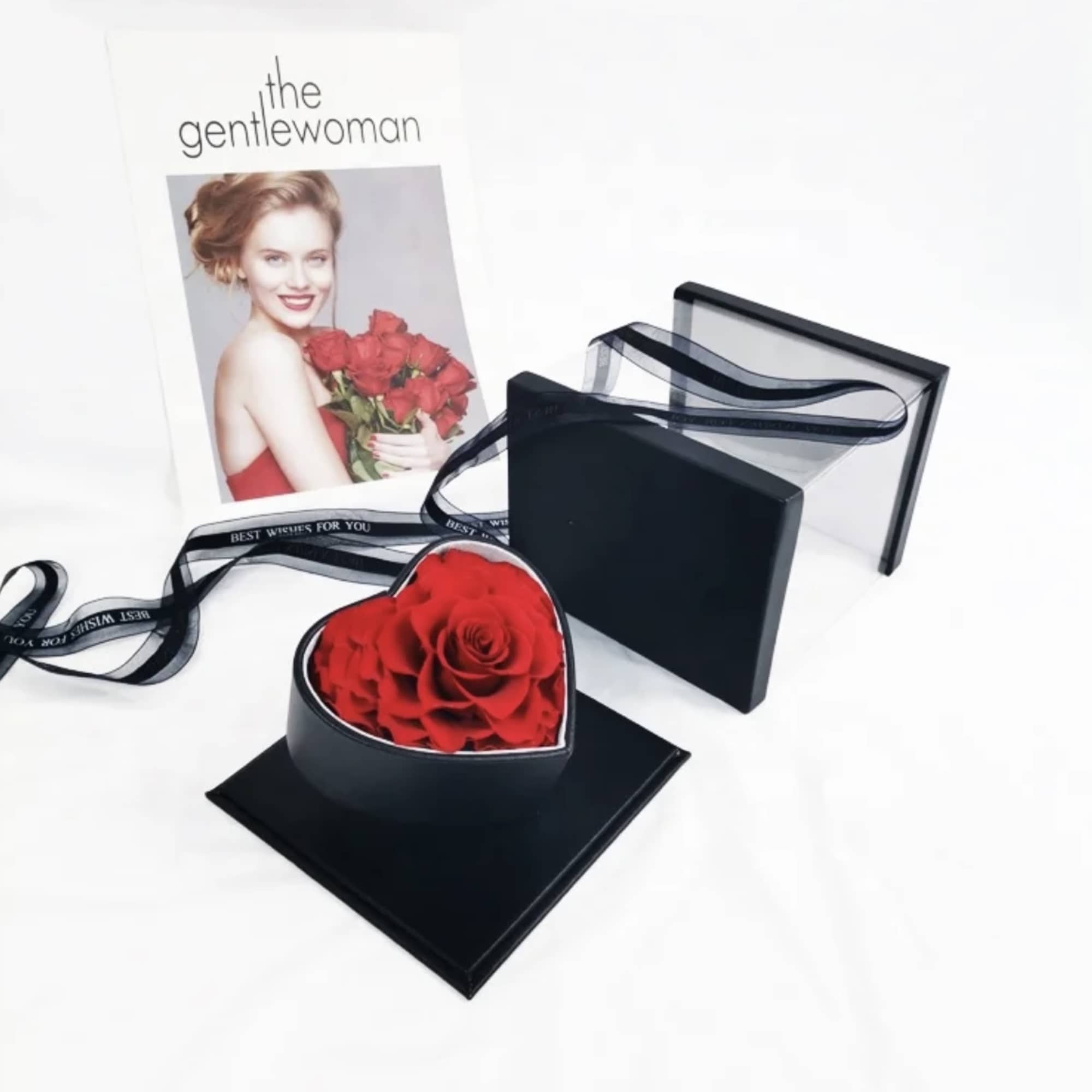Heart-shaped box of red roses with a ribbon and card