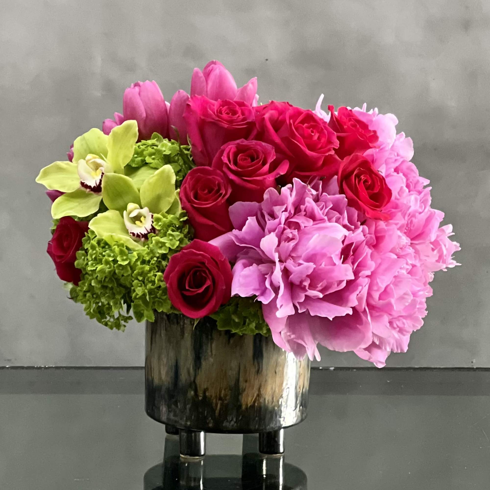 This delightful arrangement is an artistic combination of pink floral favorites. Delicate