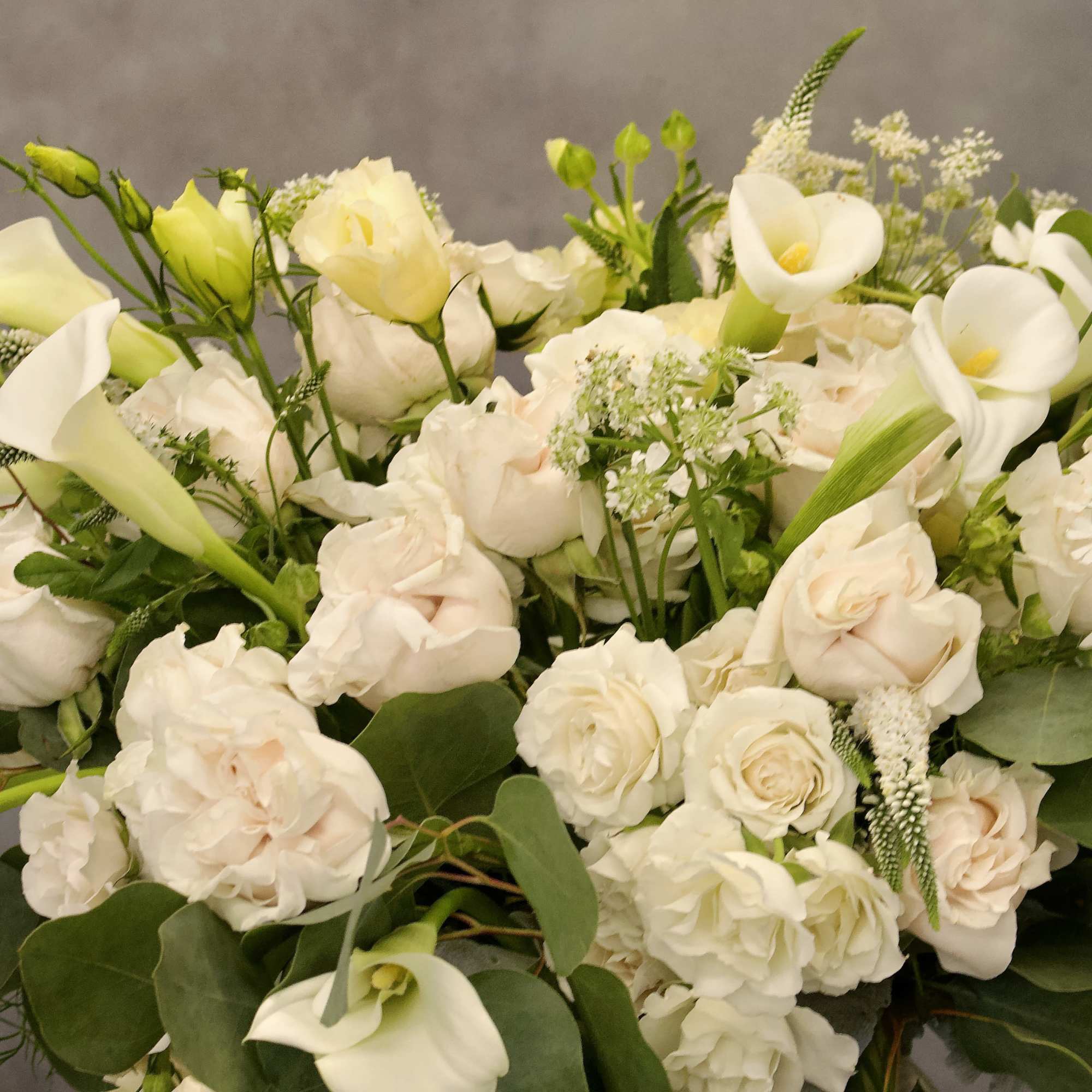 Pedestal glass vase with cream roses, calla lillies, and other complimentary floral.
Contemplate, photo 4 of 4