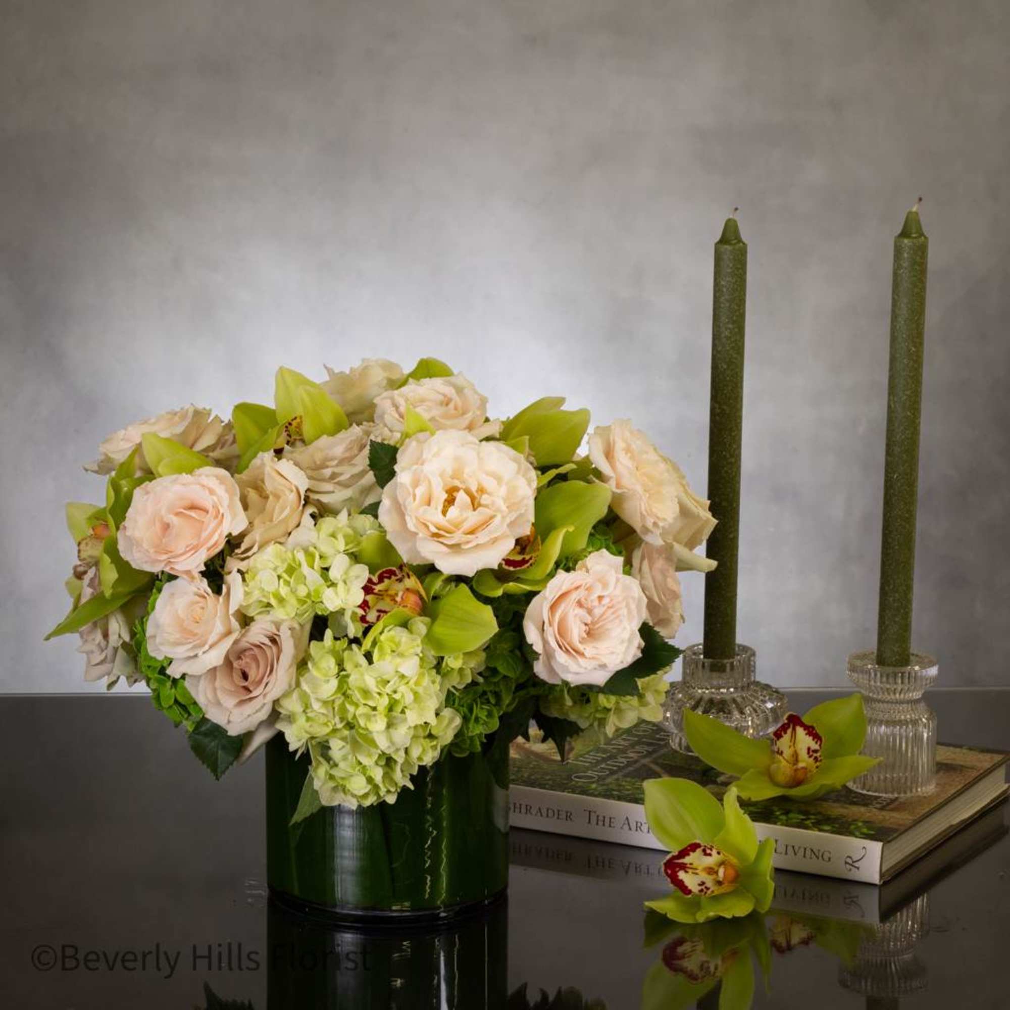 24 Champagne roses accompanied by Green cymbidium orchids and verdant floral arrangements