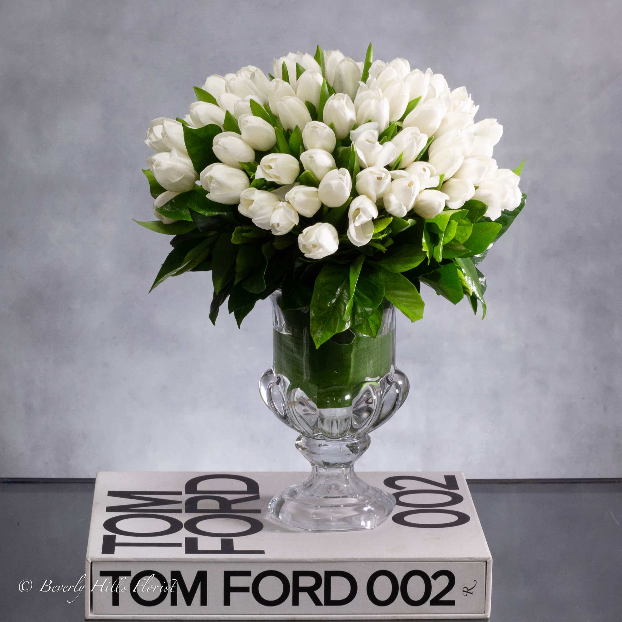White tulips symbolize purity, innocence, and new beginnings. When arranged in a