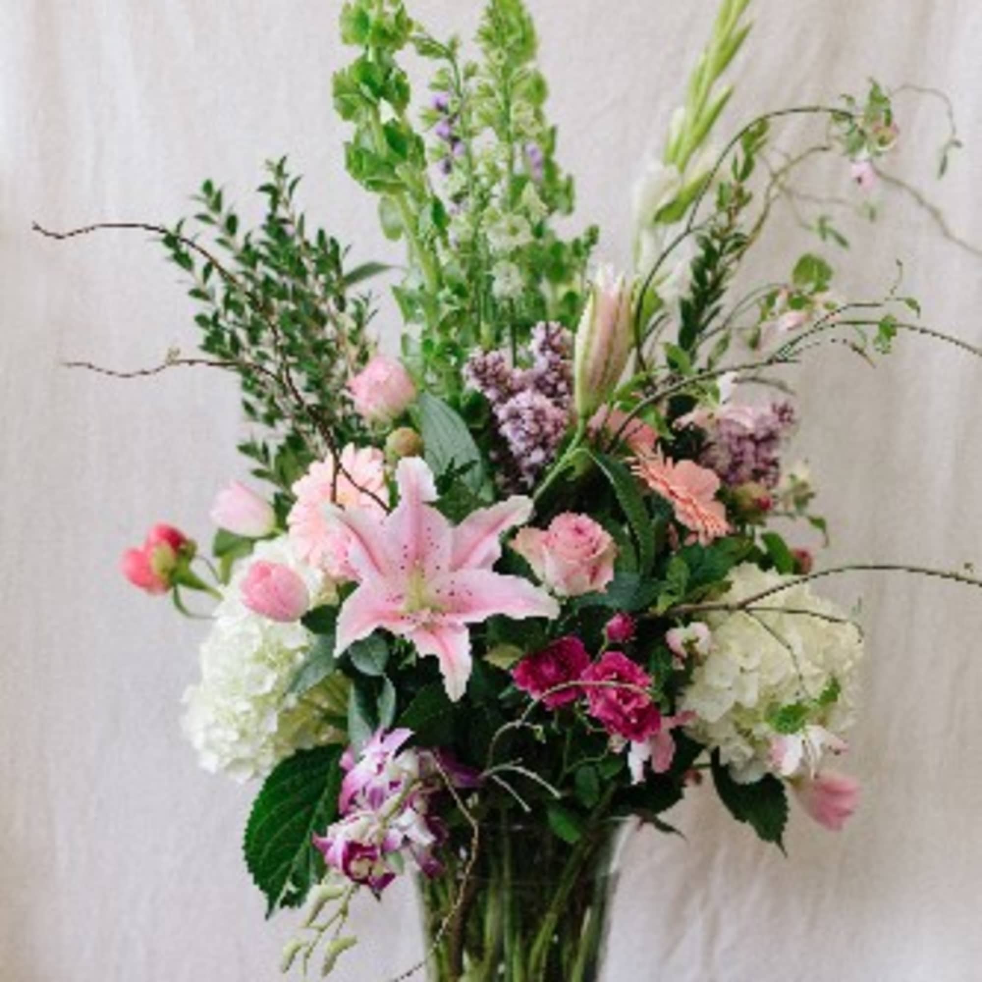 This showstopper is filled with lush hydrangeas, fragrant stargazer lilies, peonies. lilac