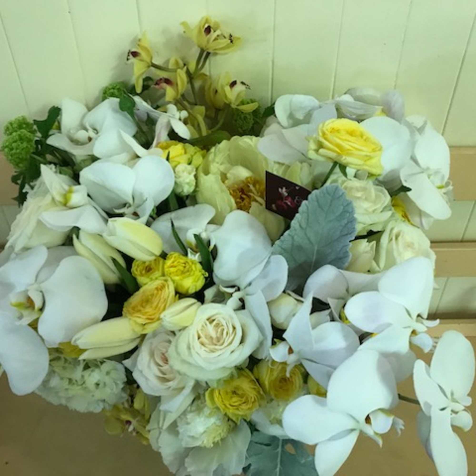 White orchids and yellow roses arranged in a bouquet