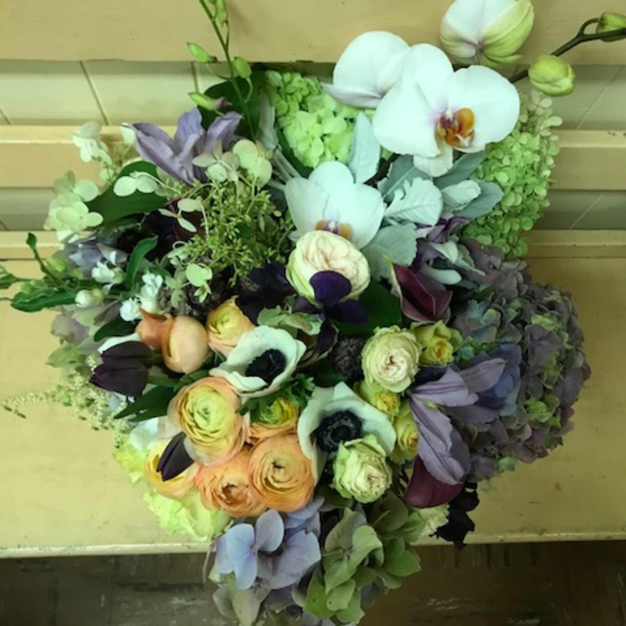 Mixed bouquet with white orchids and peach ranunculus