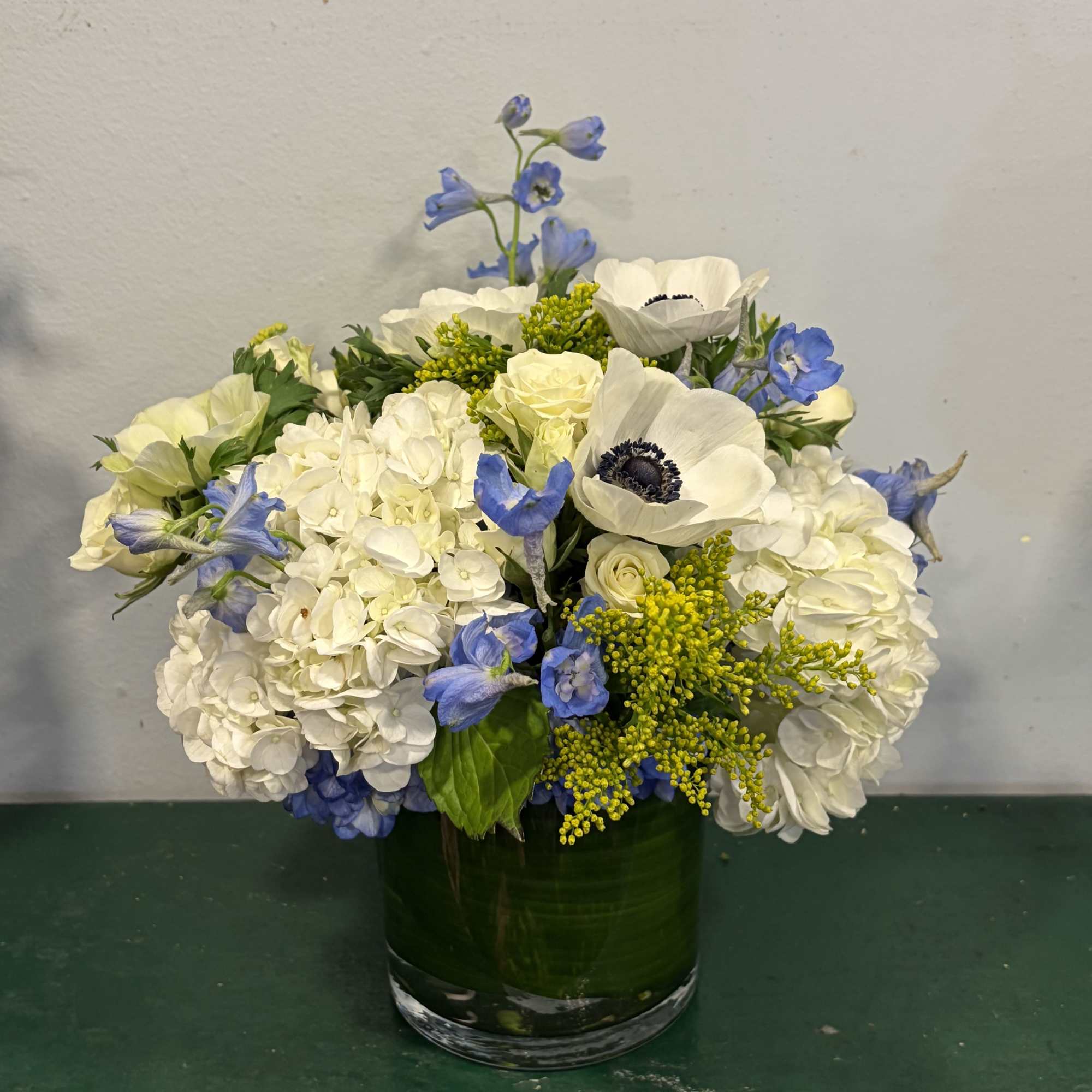 Crisp white hydrangea clusters and a single striking white anemone with its, photo 2 of 2