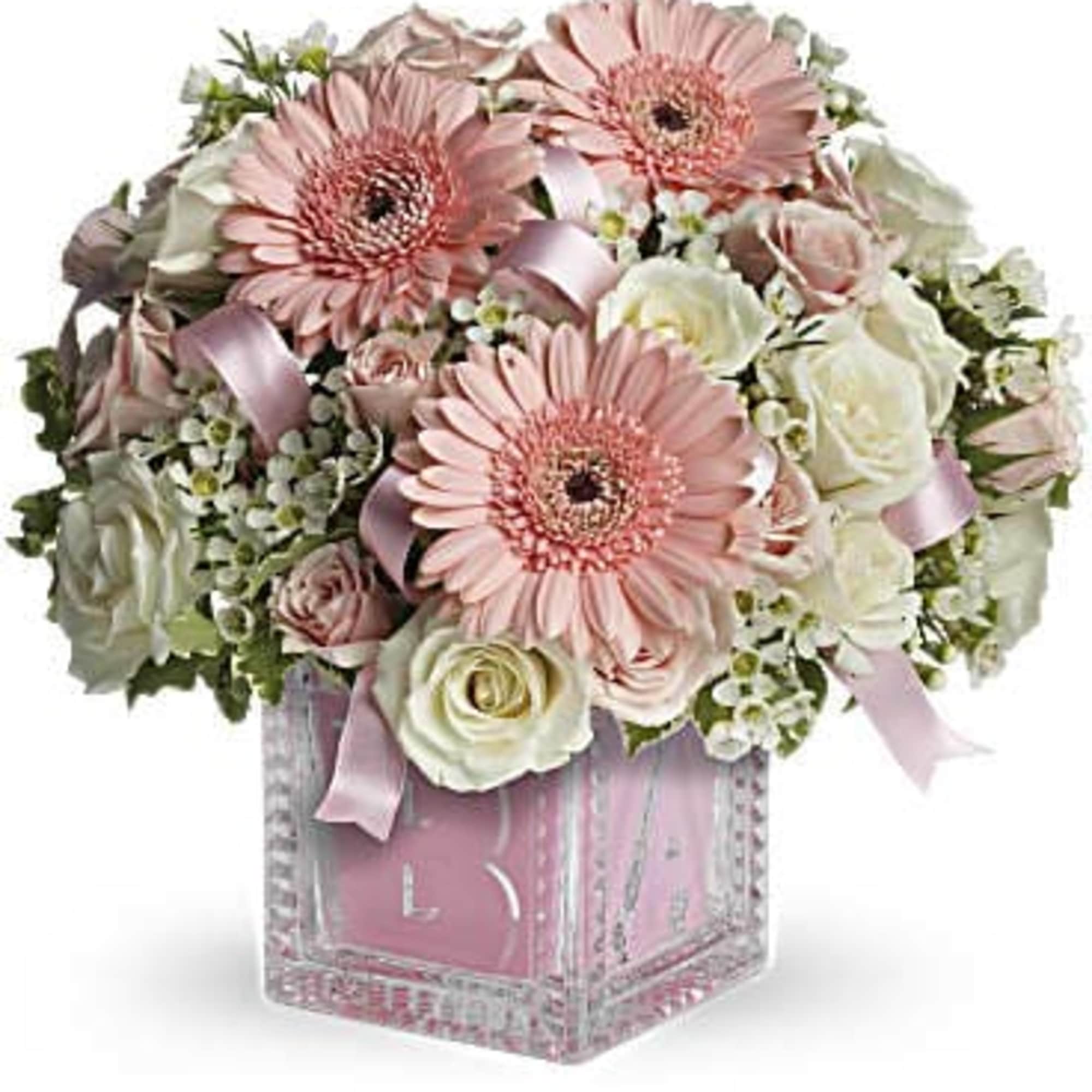 Pink gerbera daisies and white roses in a clear square vase