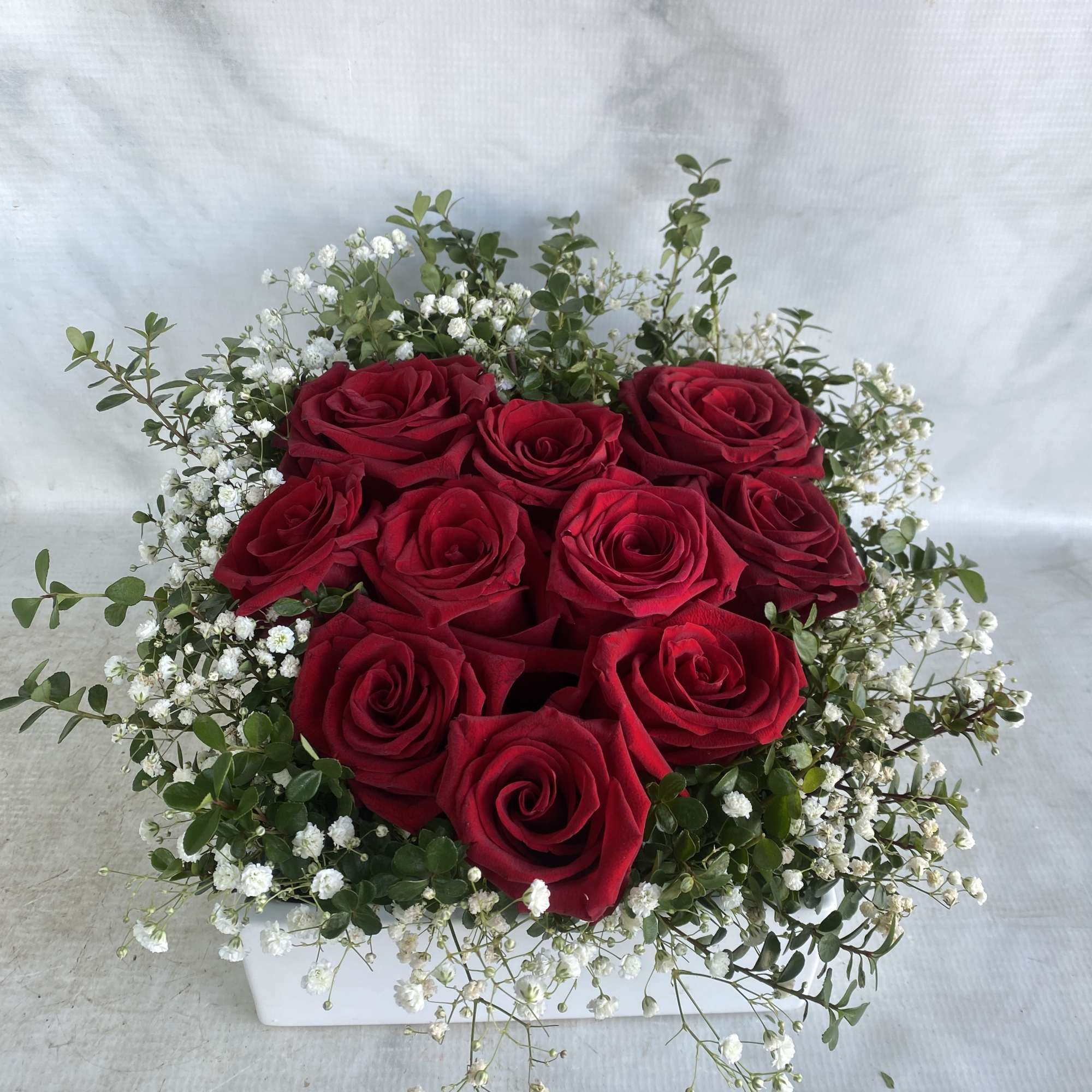 A white ceramic container with 10 roses in the shape of a, photo 2 of 2