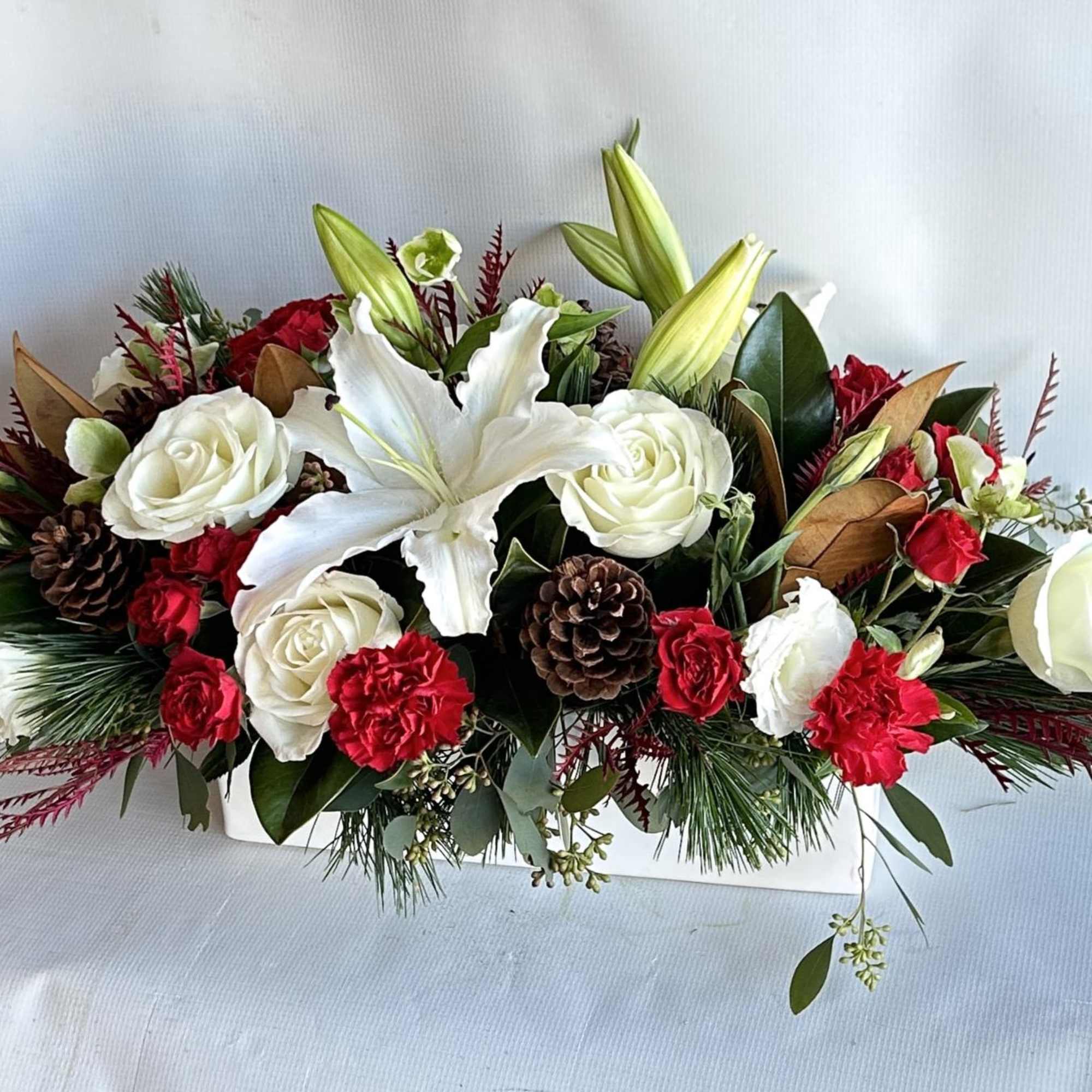 A Holiday arrangement with red roses, orchids, hanging amaranthus, stargazer lilies, dianthus, photo 2 of 2