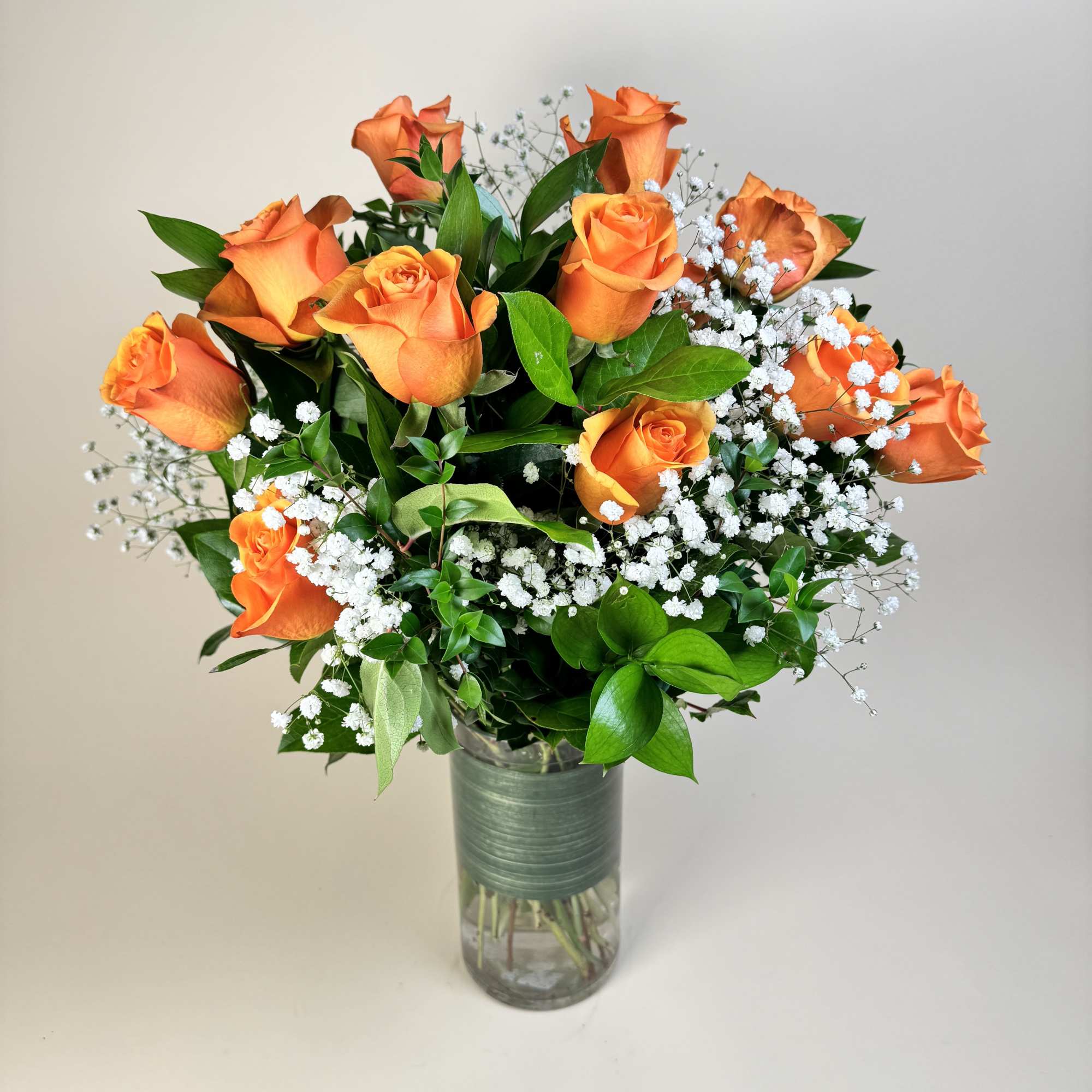 Radiating warmth and energy, these vibrant orange roses symbolize enthusiasm, passion, and