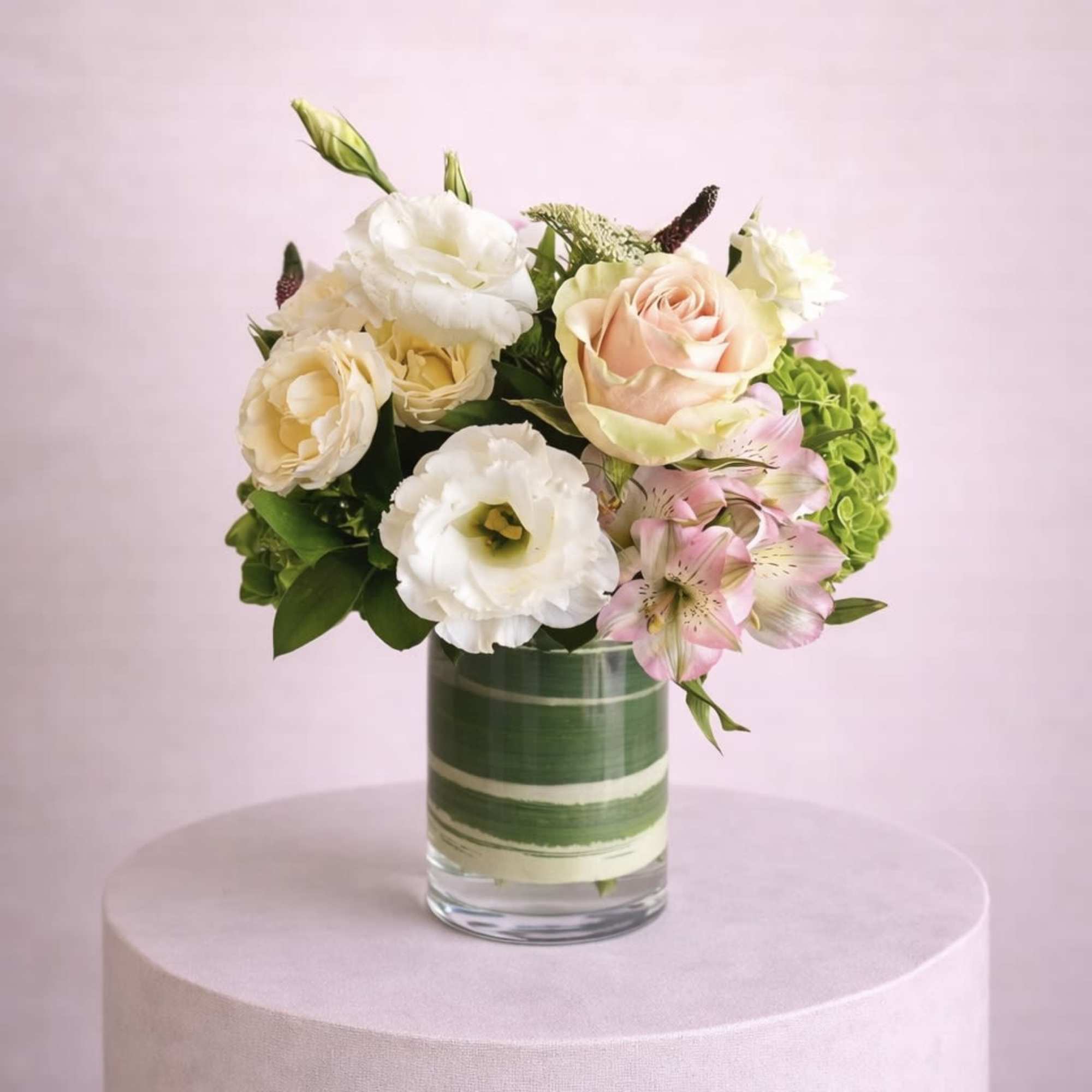 A lush and romantic floral arrangement featuring an exquisite blend of roses