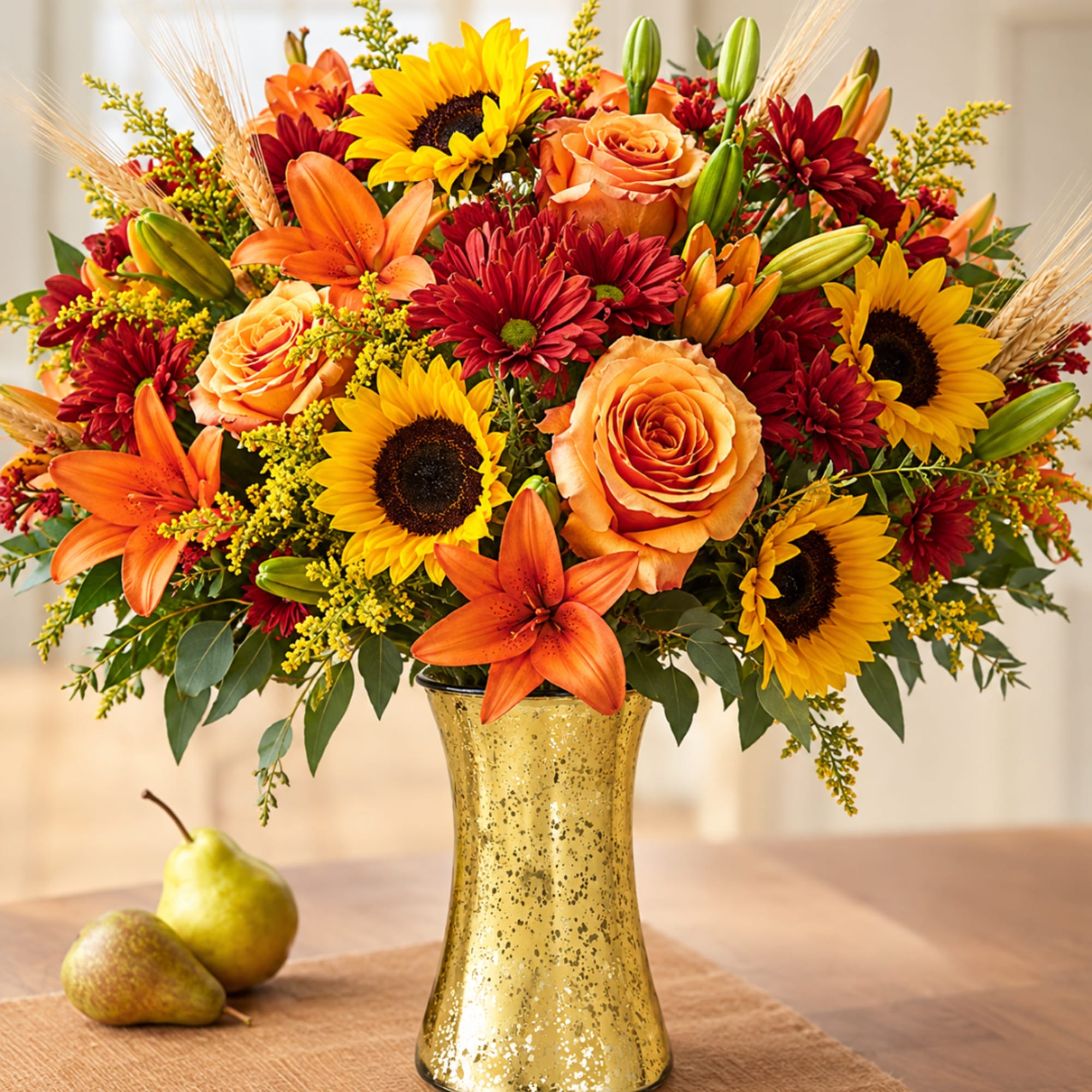 Autumn bouquet of sunflowers, orange lilies, and roses in a gold vase
