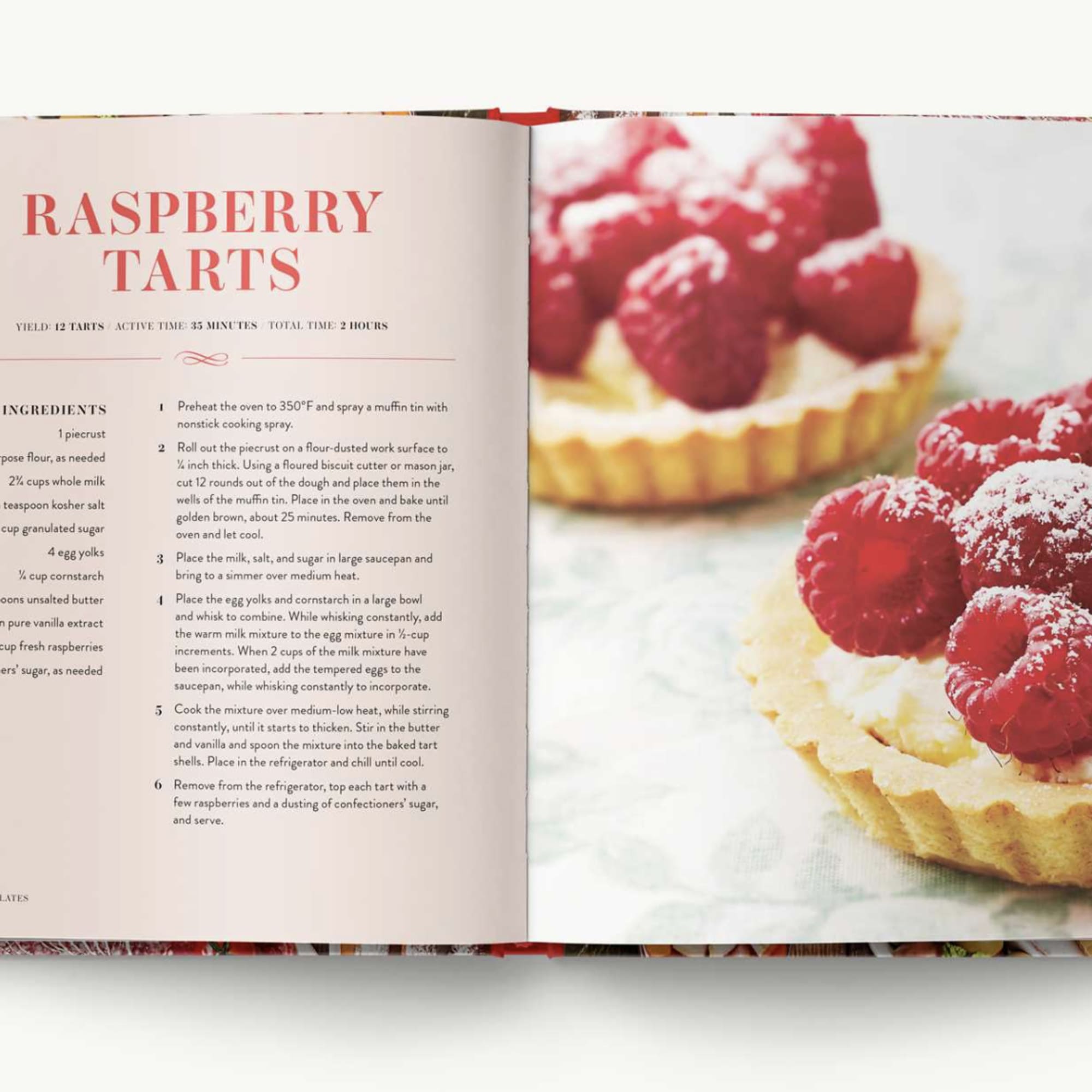 Open cookbook showing a raspberry tart recipe and tart photos