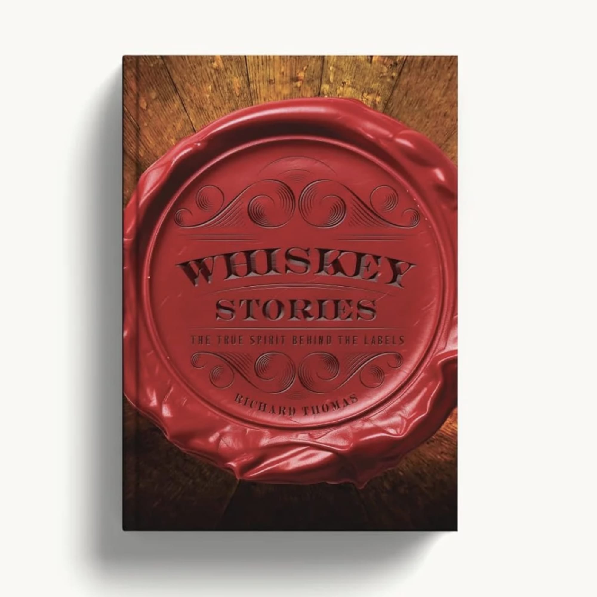 Red whiskey bottle cap on a wooden surface