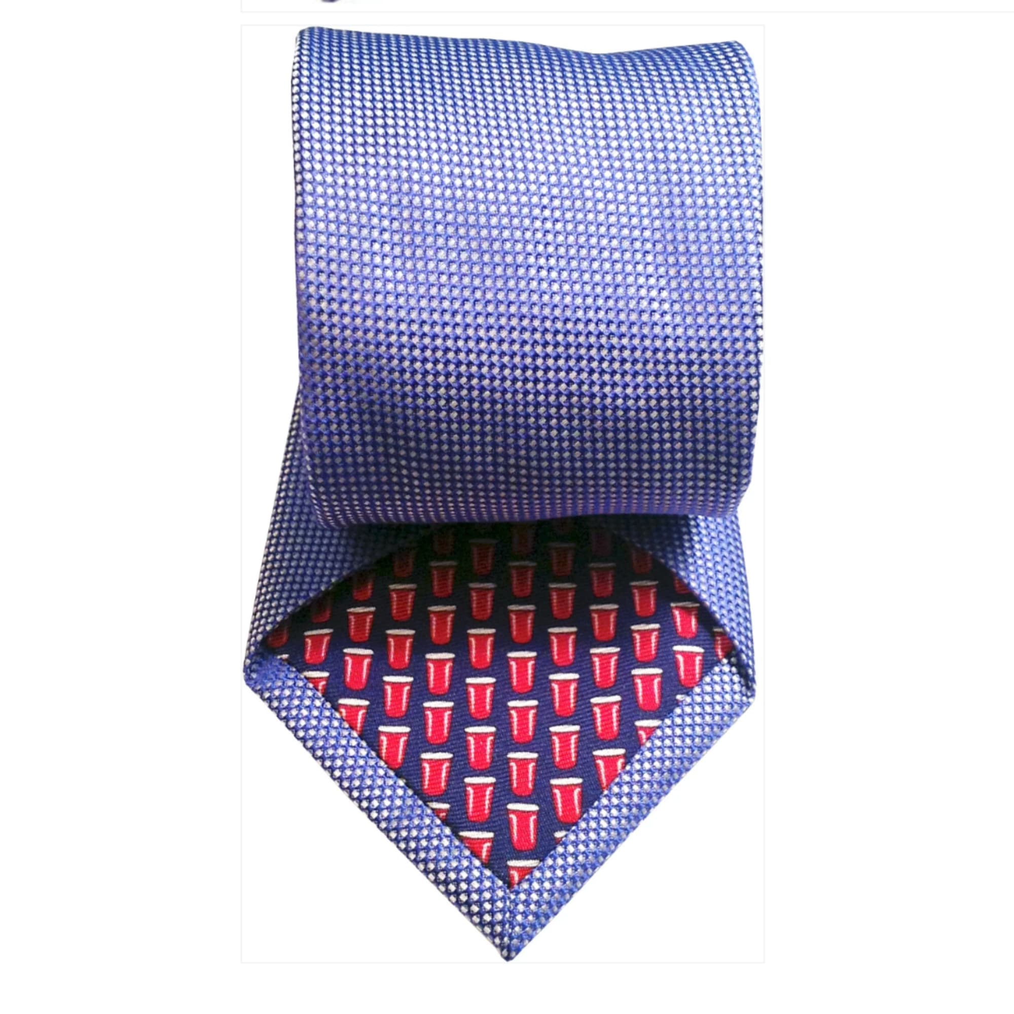 Blue patterned necktie with a red cup print on the lining