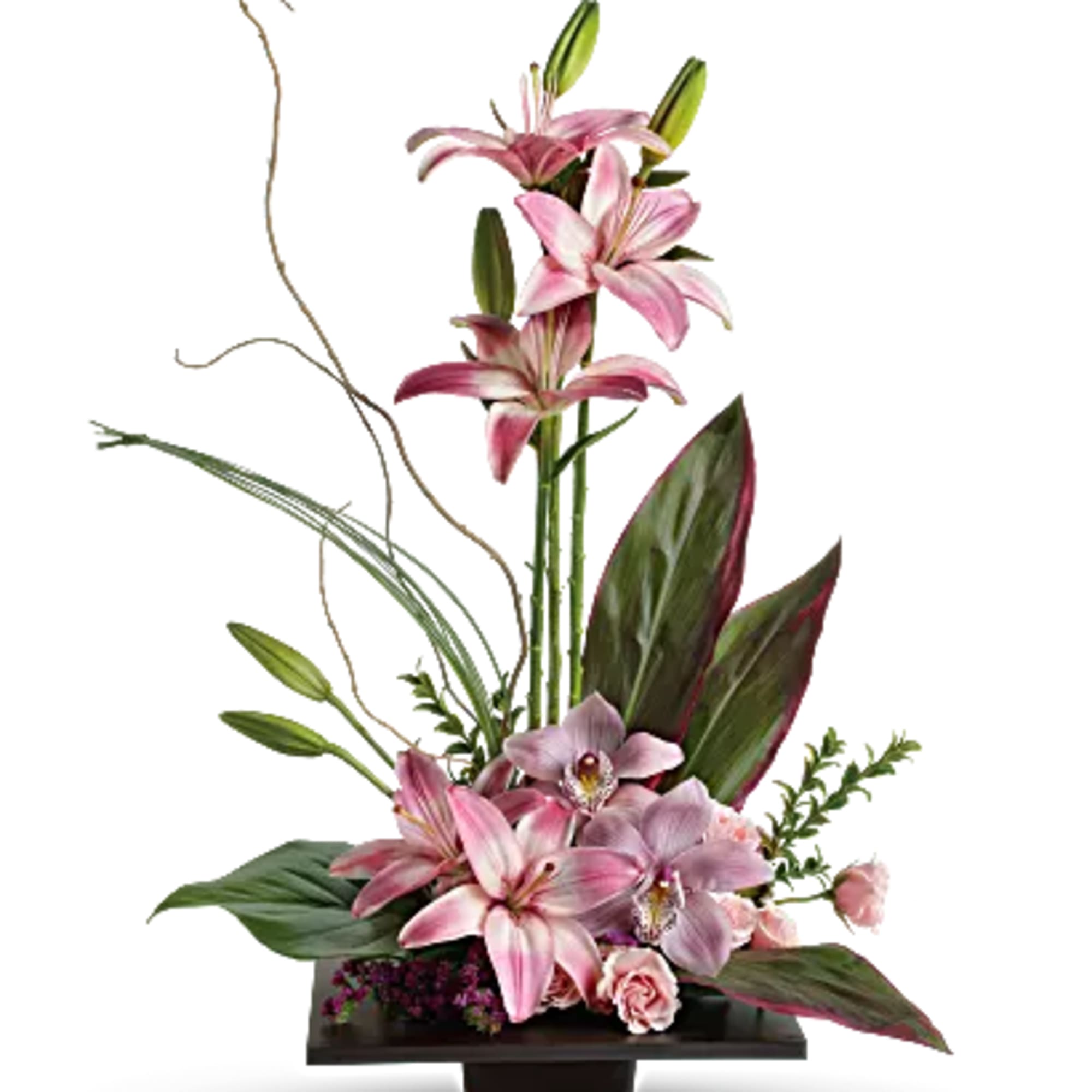 Pink lilies and orchids in a low rectangular vase