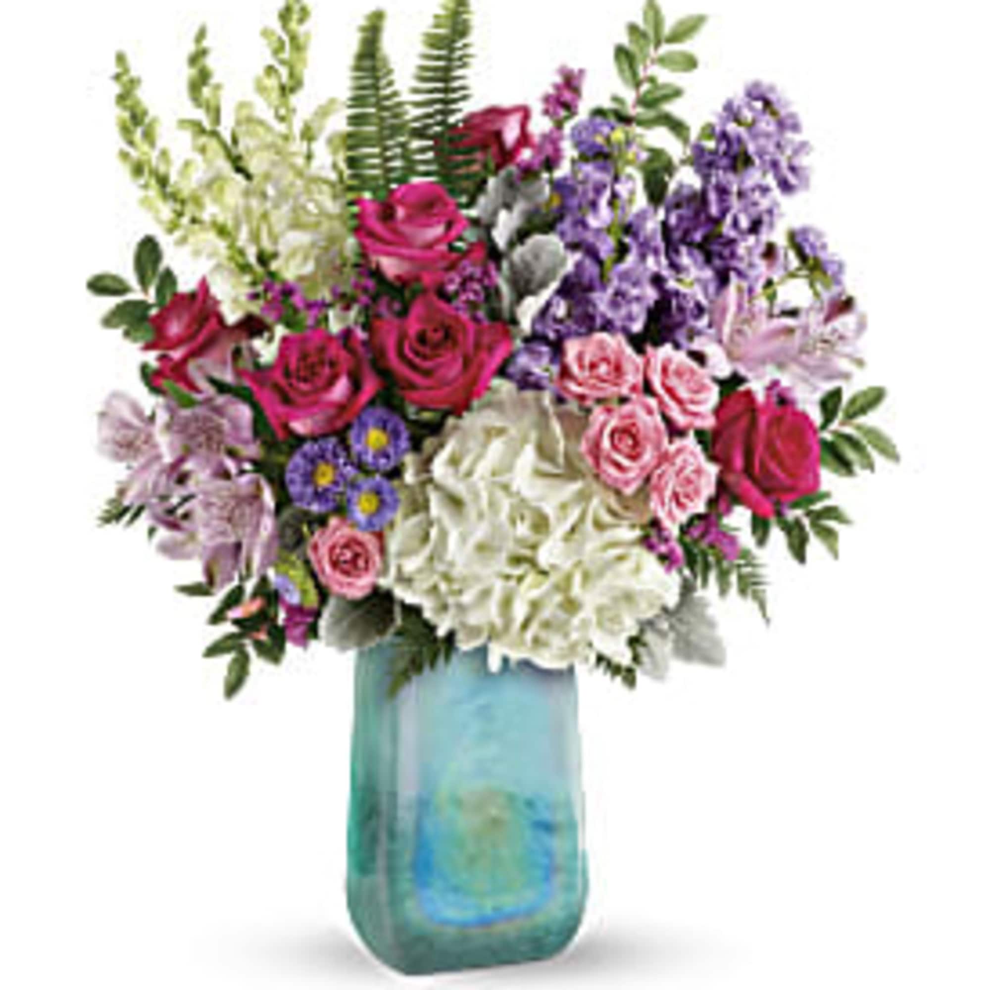 Mixed bouquet of roses, hydrangeas, and purple flowers in a blue glass vase