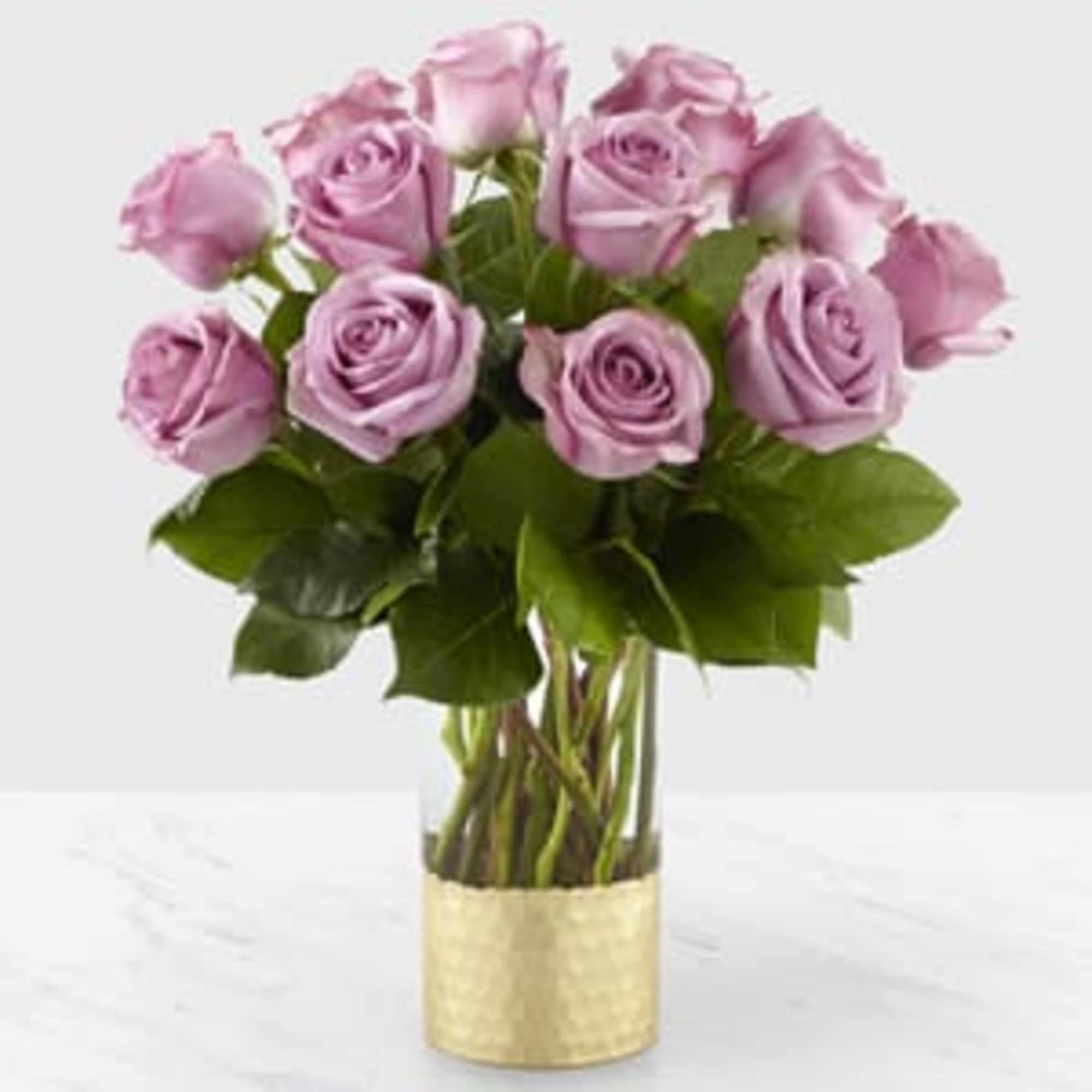 Bouquet of lavender roses in a gold vase