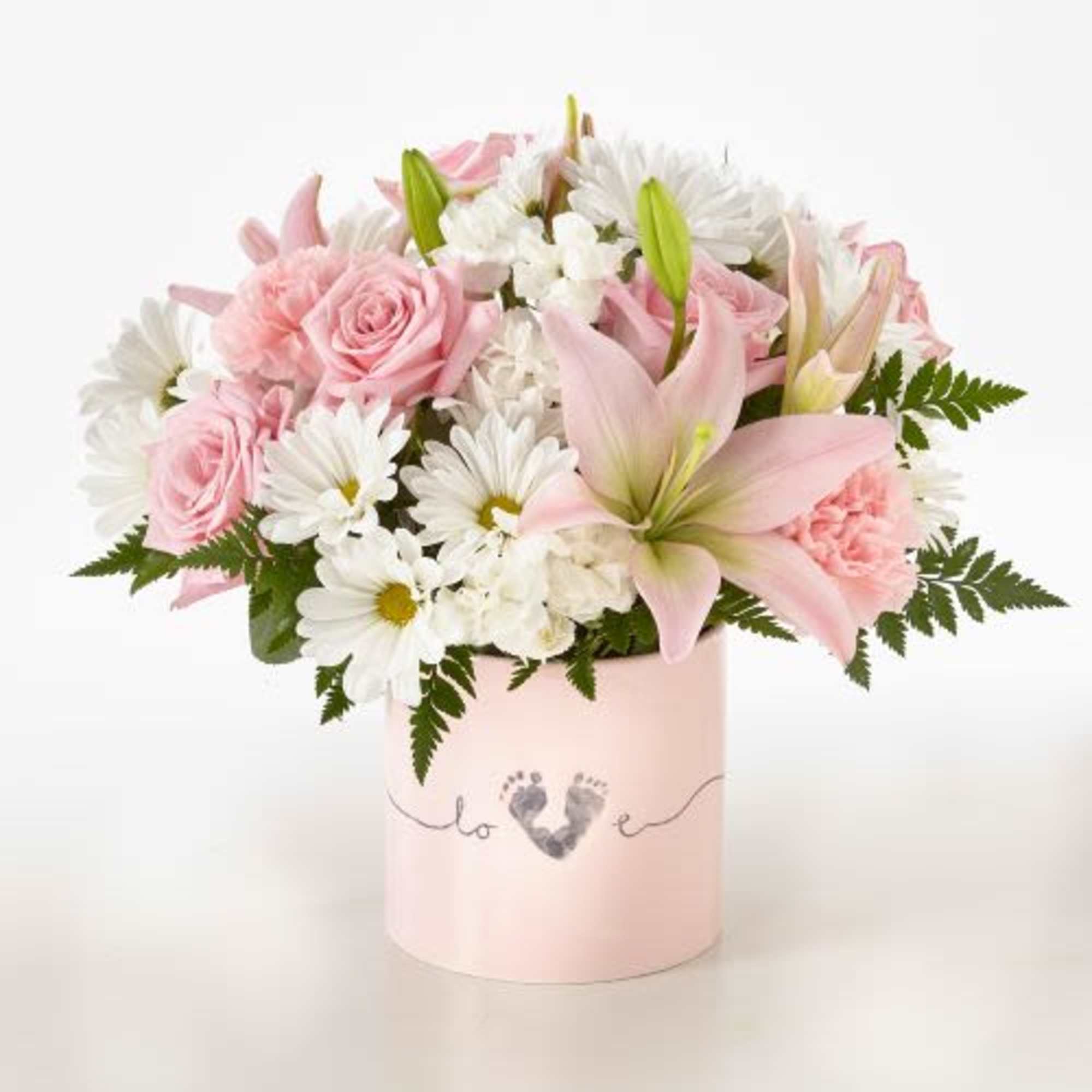 Pink roses and lilies in a pale pink box with white daisies