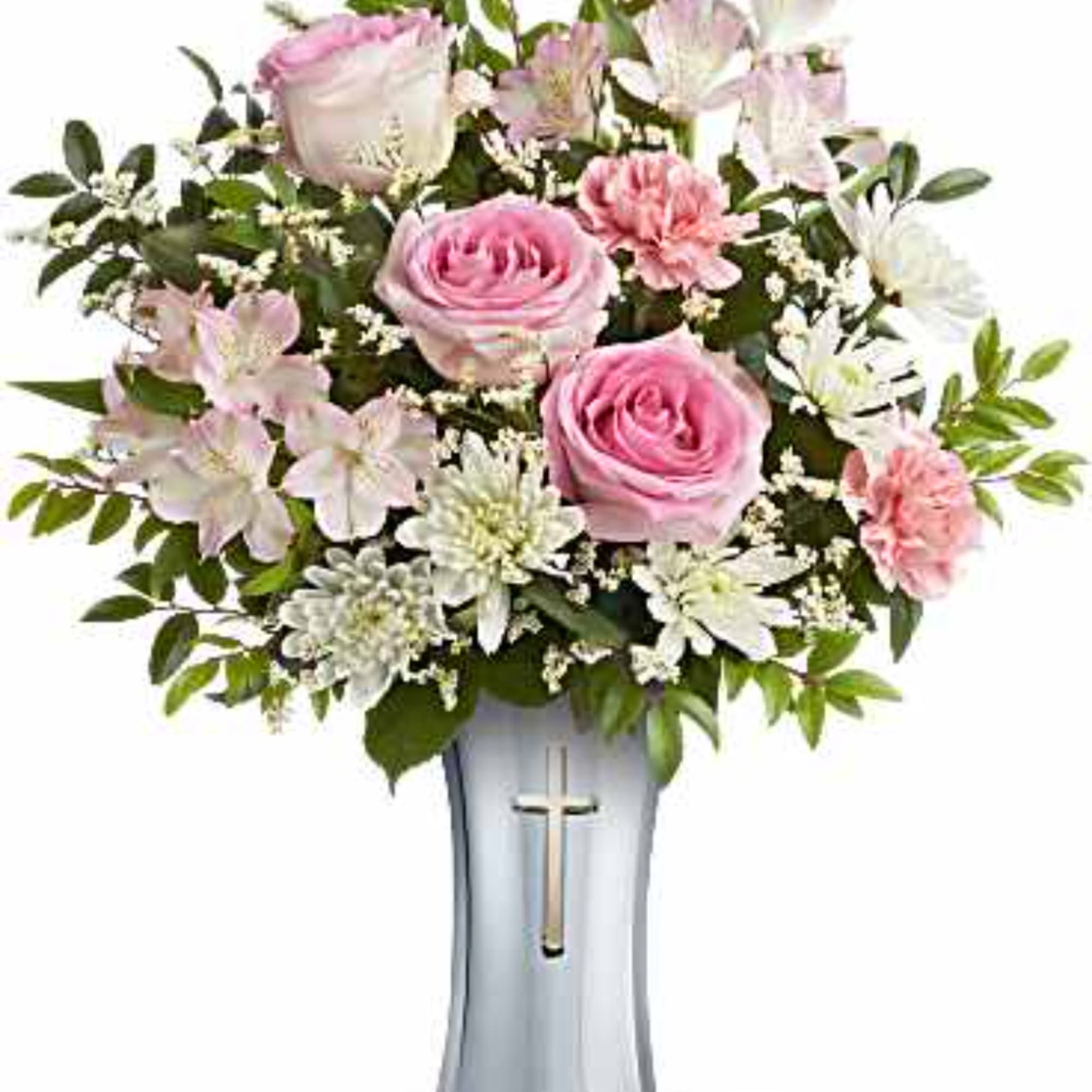 Pink roses and white flowers arranged in a tall vase with a cross emblem