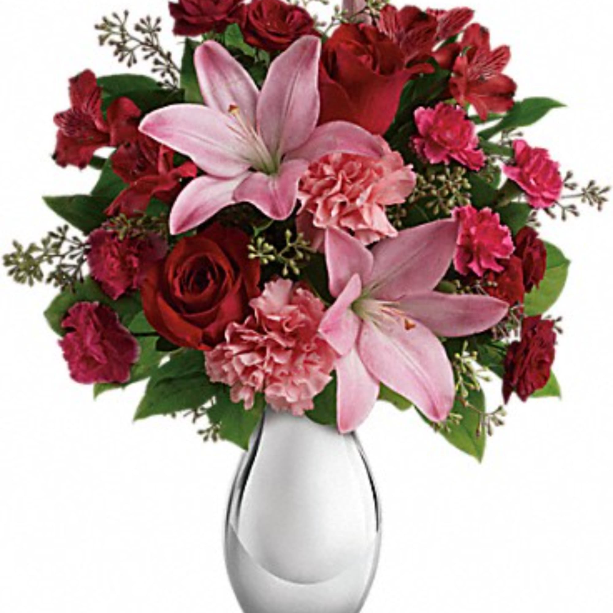 Pink lilies and red roses in a clear glass vase