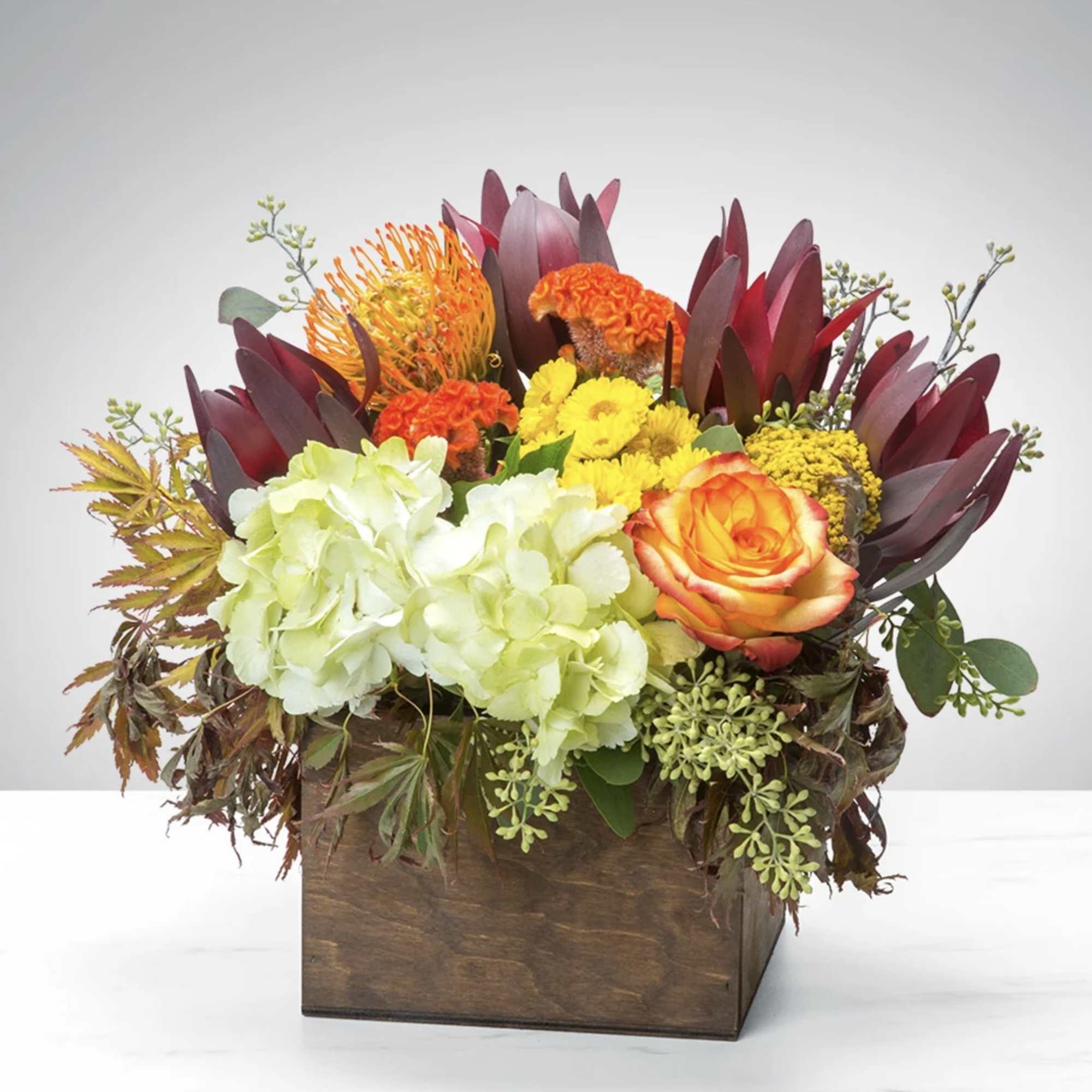 This arrangement brings meaning to the word "Happiness" with spring flowers designed