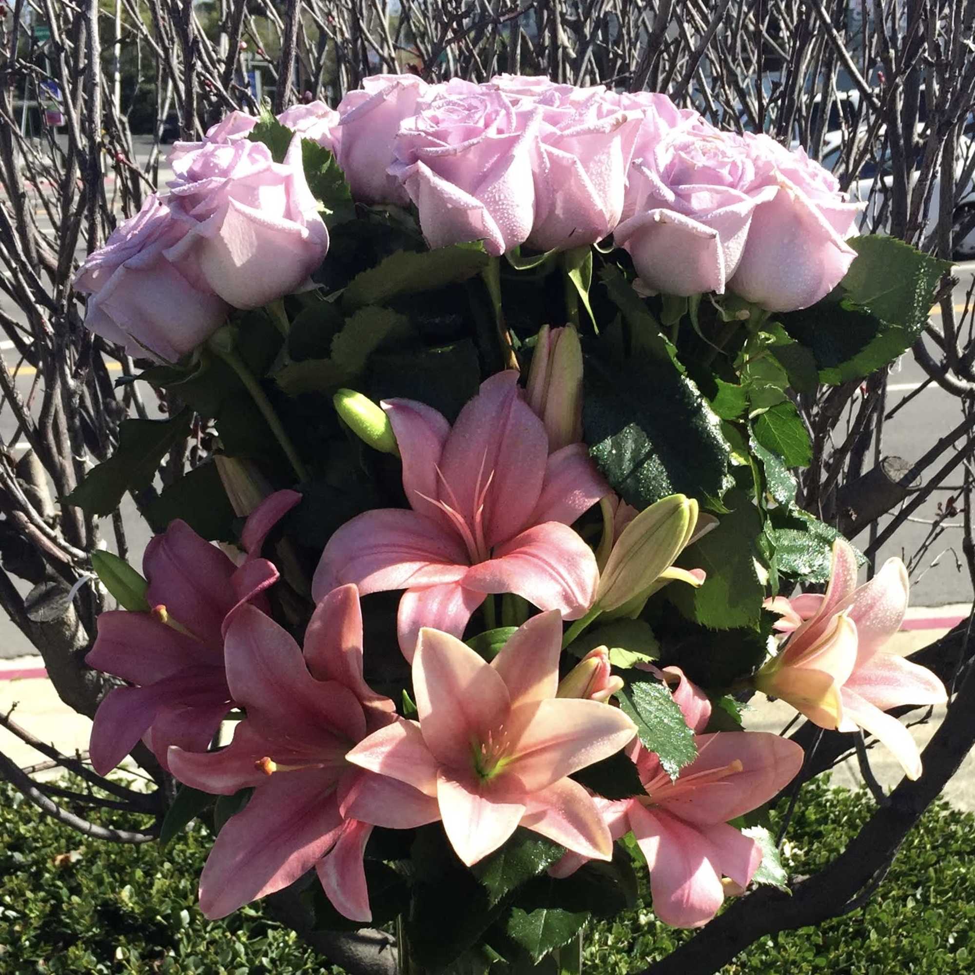 Pink roses and lilies arranged in a bouquet