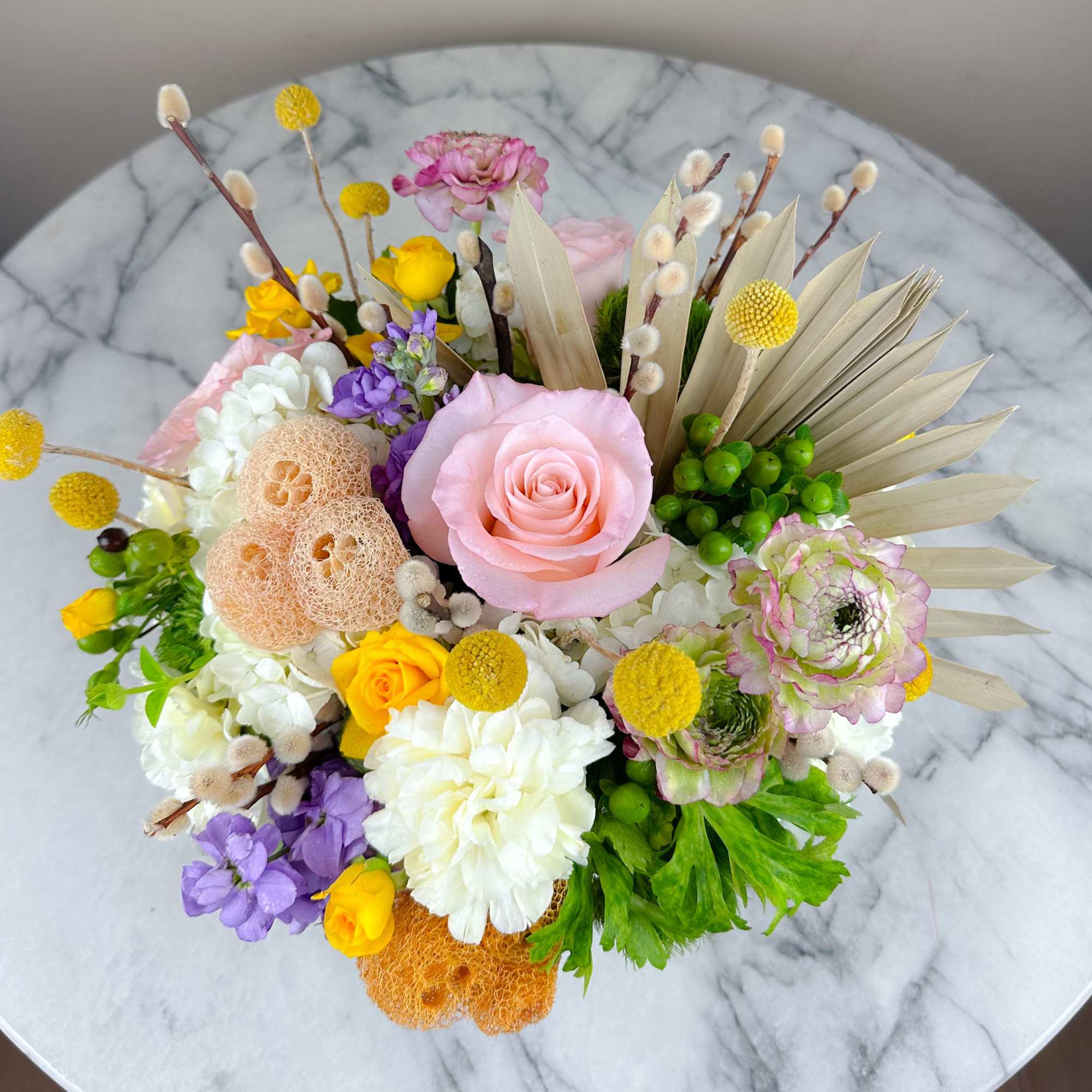 Mixed bouquet with a pink rose, white blooms, and yellow accents