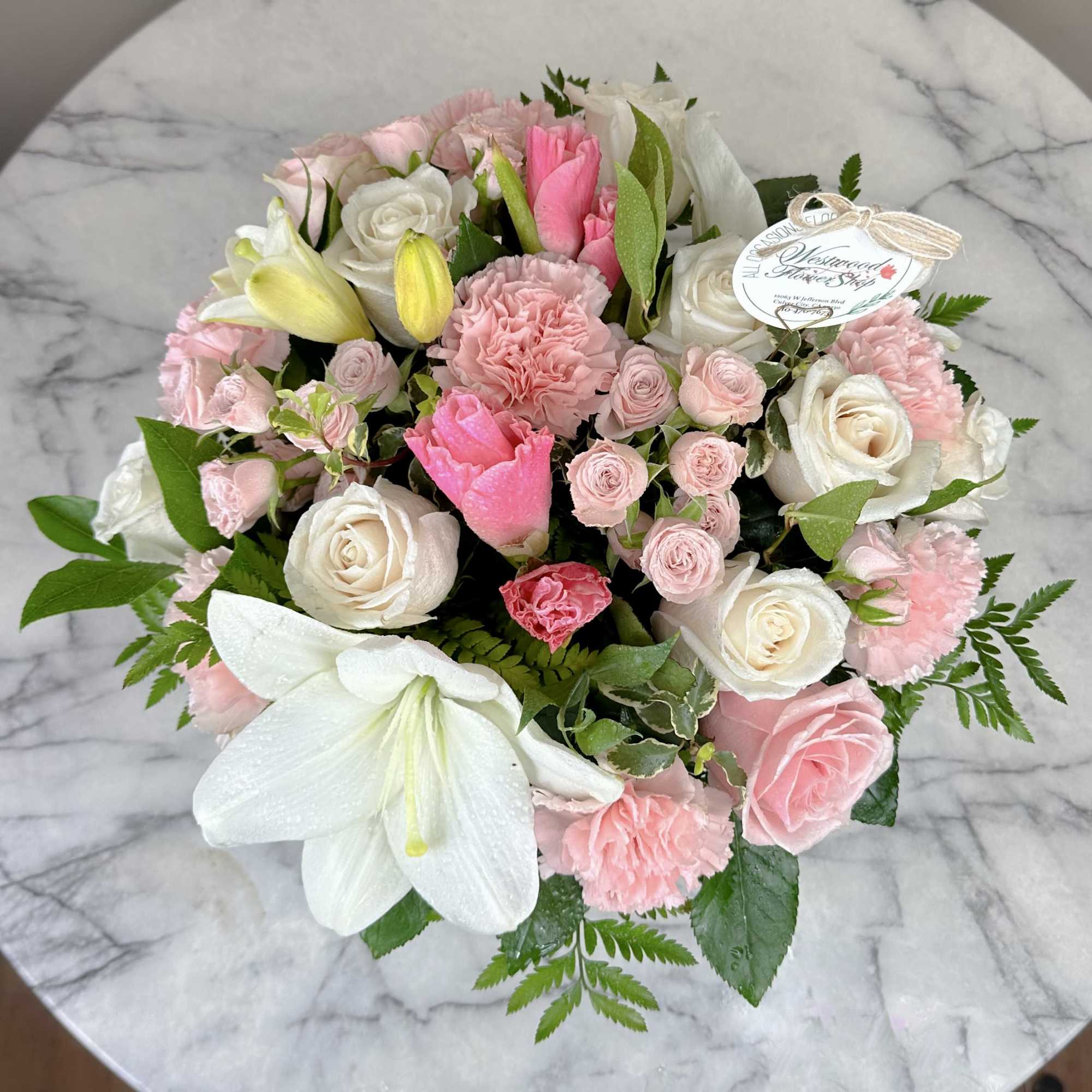 Pink and white bouquet with roses, carnations, and lilies