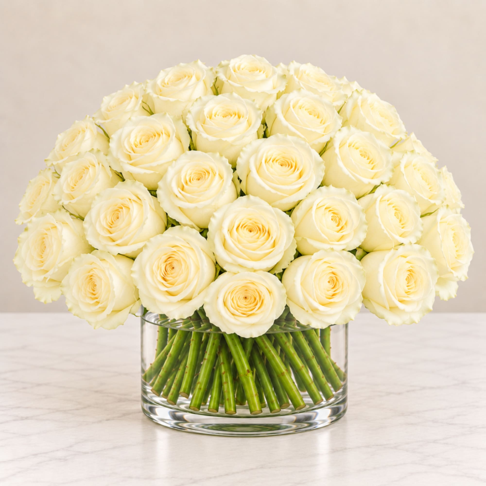 Bouquet of cream roses in a clear glass vase