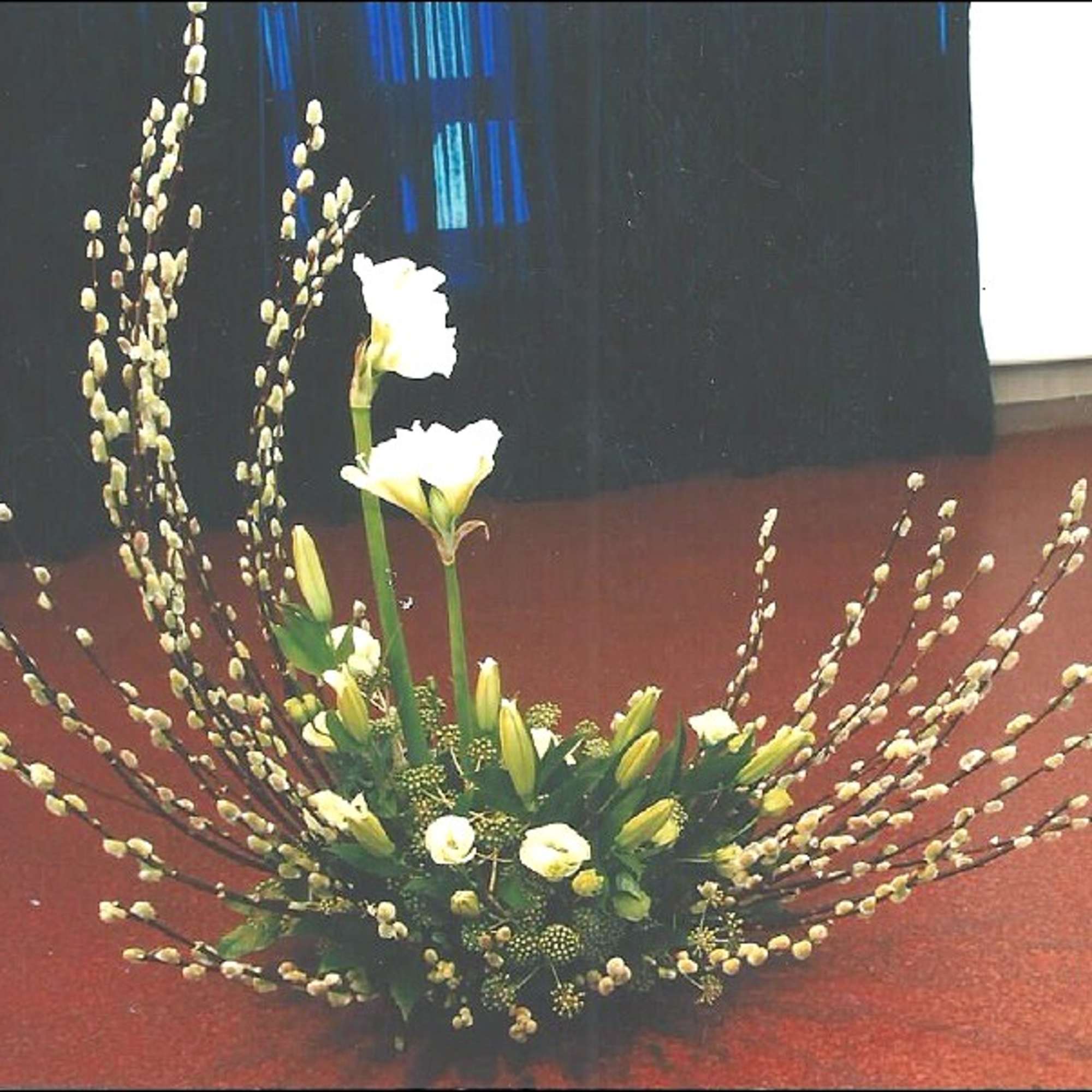 White floral arrangement with tall branching stems and small blooms