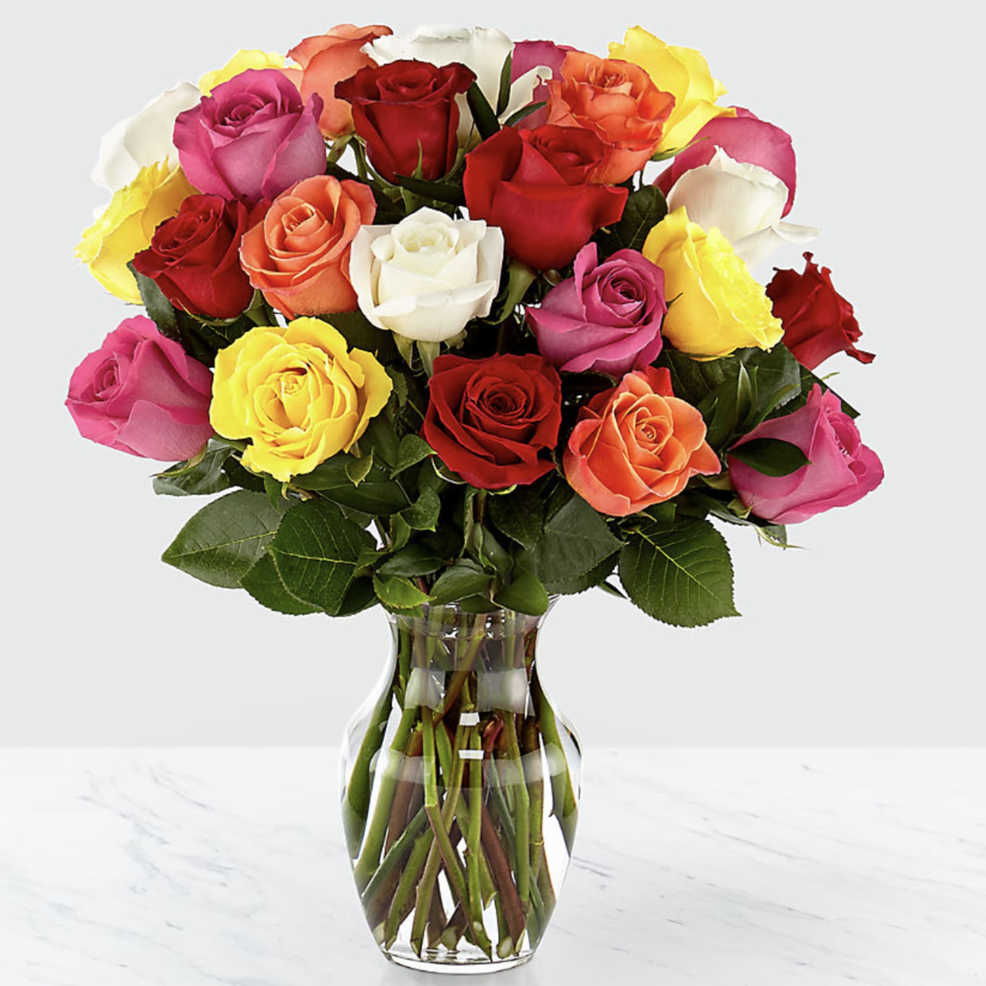 Mixed roses in a clear glass vase