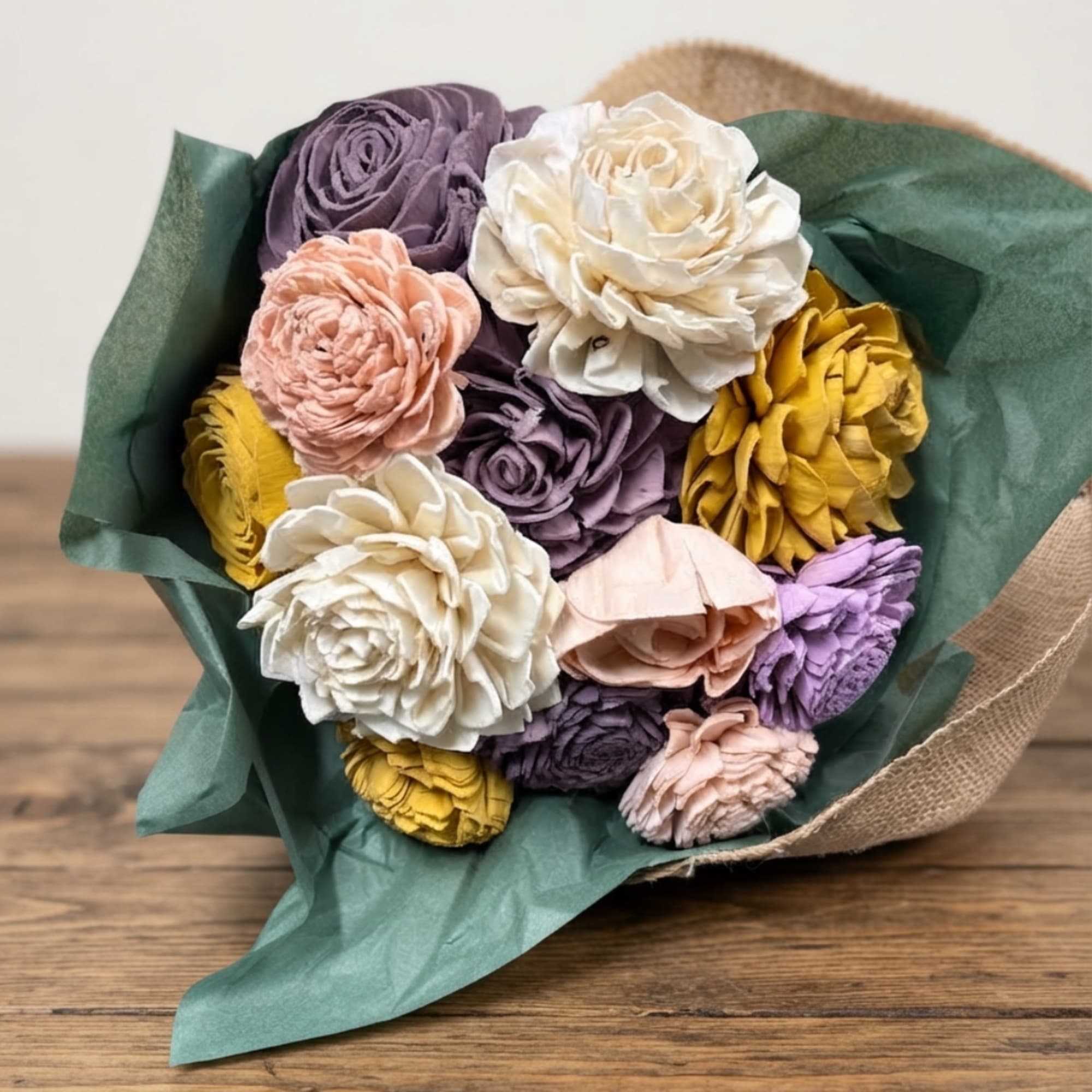 Bouquet of multicolored roses wrapped in green paper
