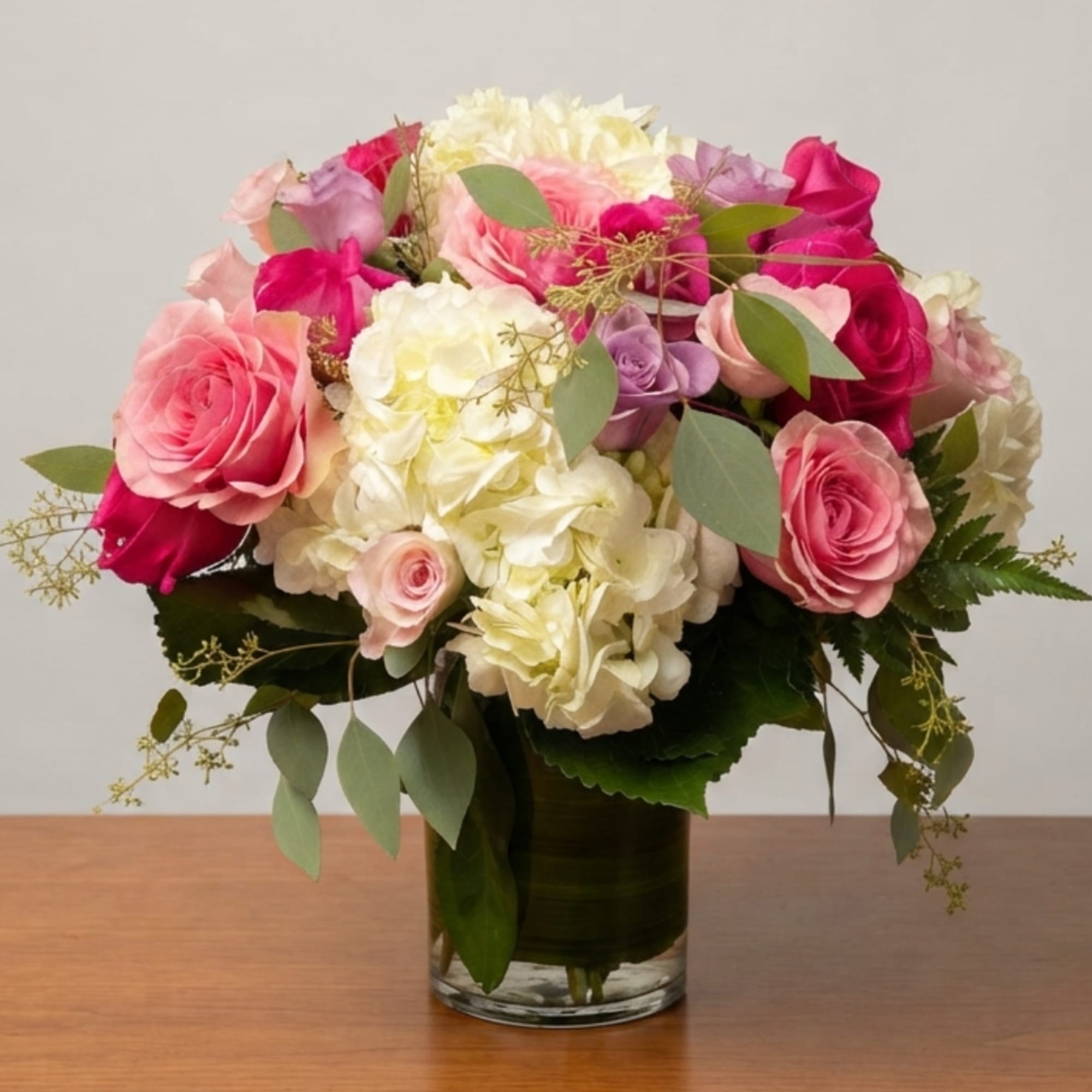 Pink and white rose bouquet in a clear glass vase, photo 2 of 4