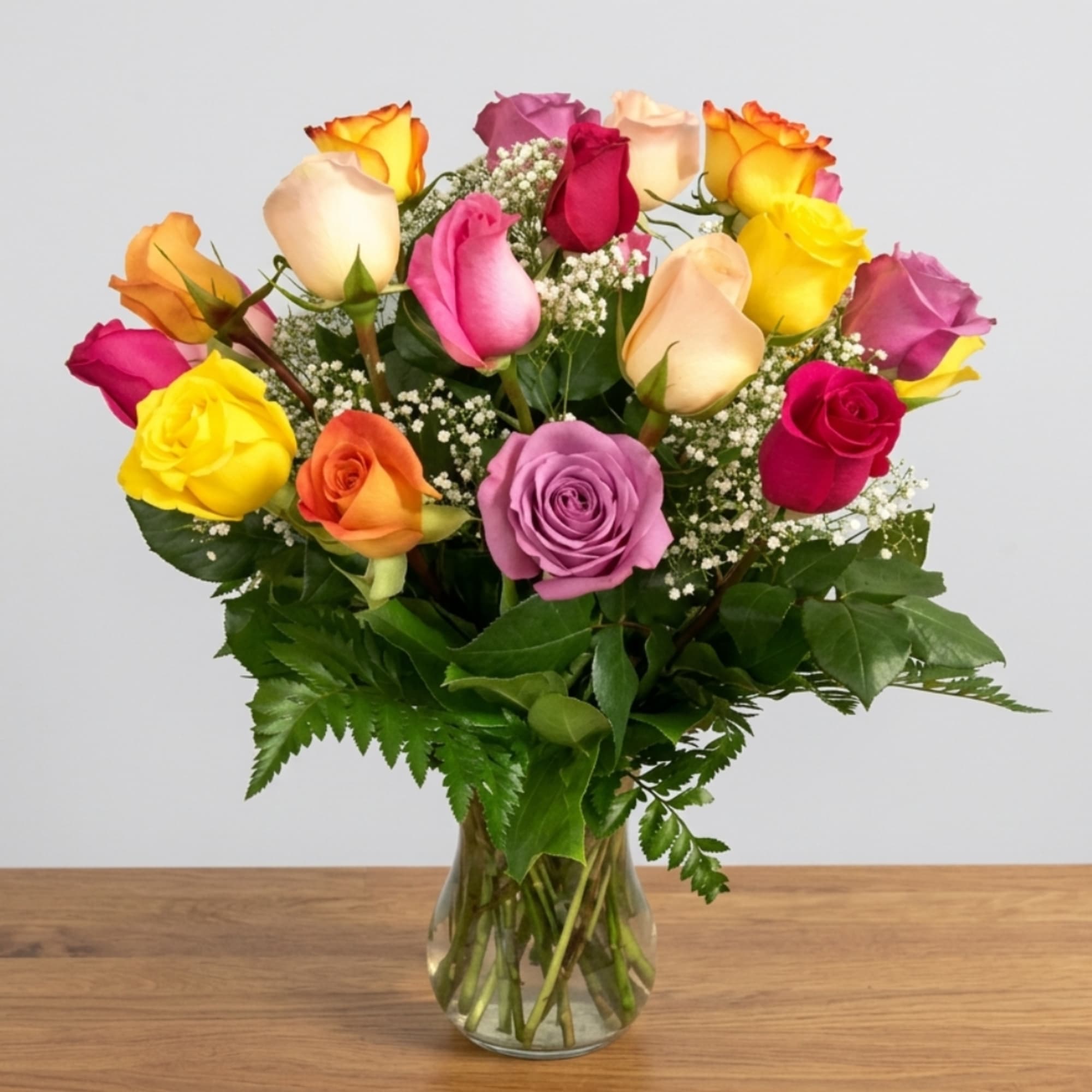 Mixed-color rose bouquet in a clear glass vase