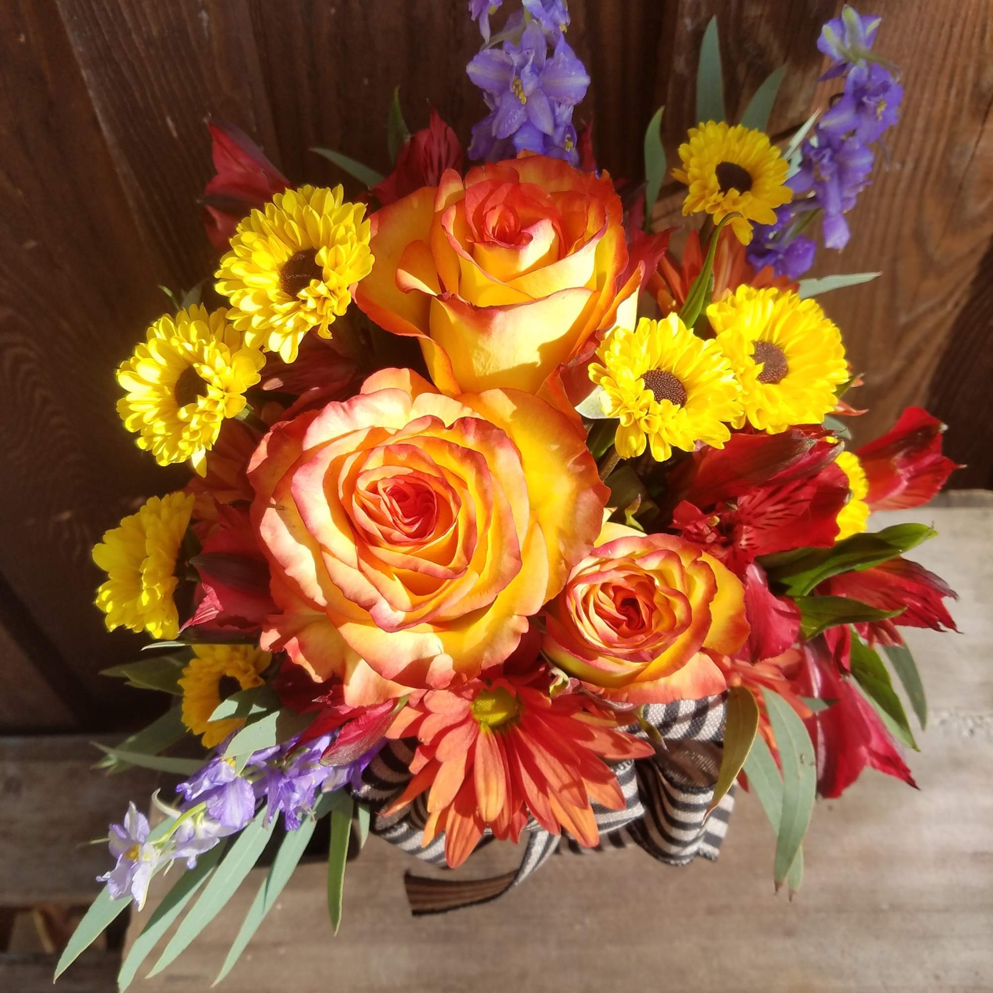 A ceramic pumpkin filled with traditional fall flowers, full of color and, photo 2 of 2