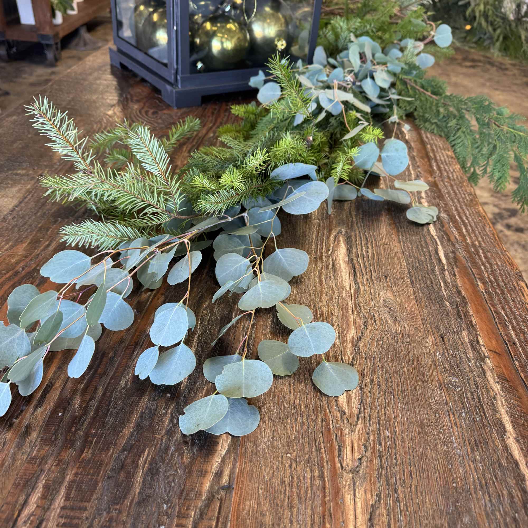 Eucalyptus and evergreen garland on a wooden table
