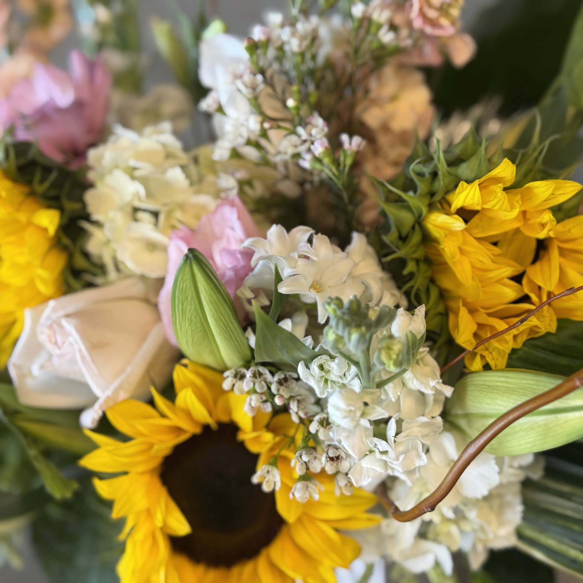 Bouquet with yellow sunflowers, white blooms, and pink flowers