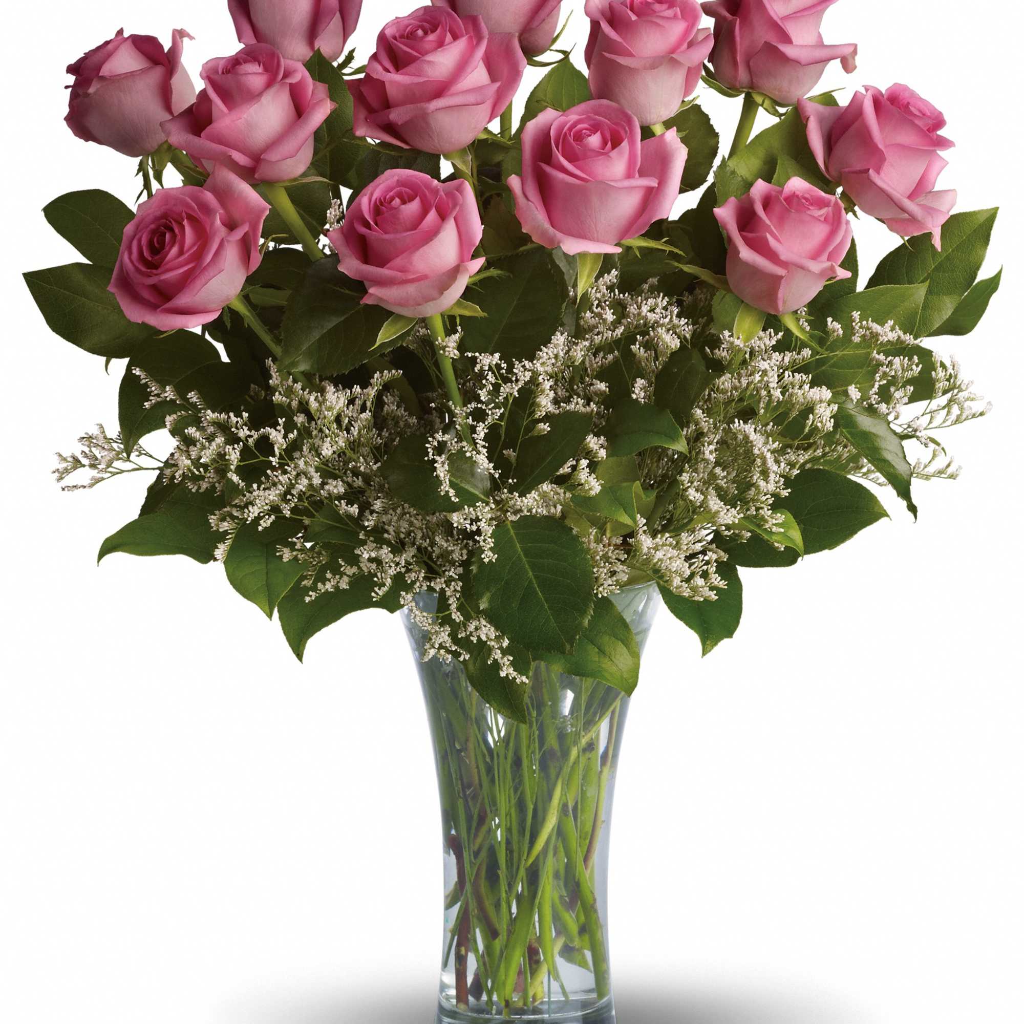 Pink roses arranged in a clear glass vase