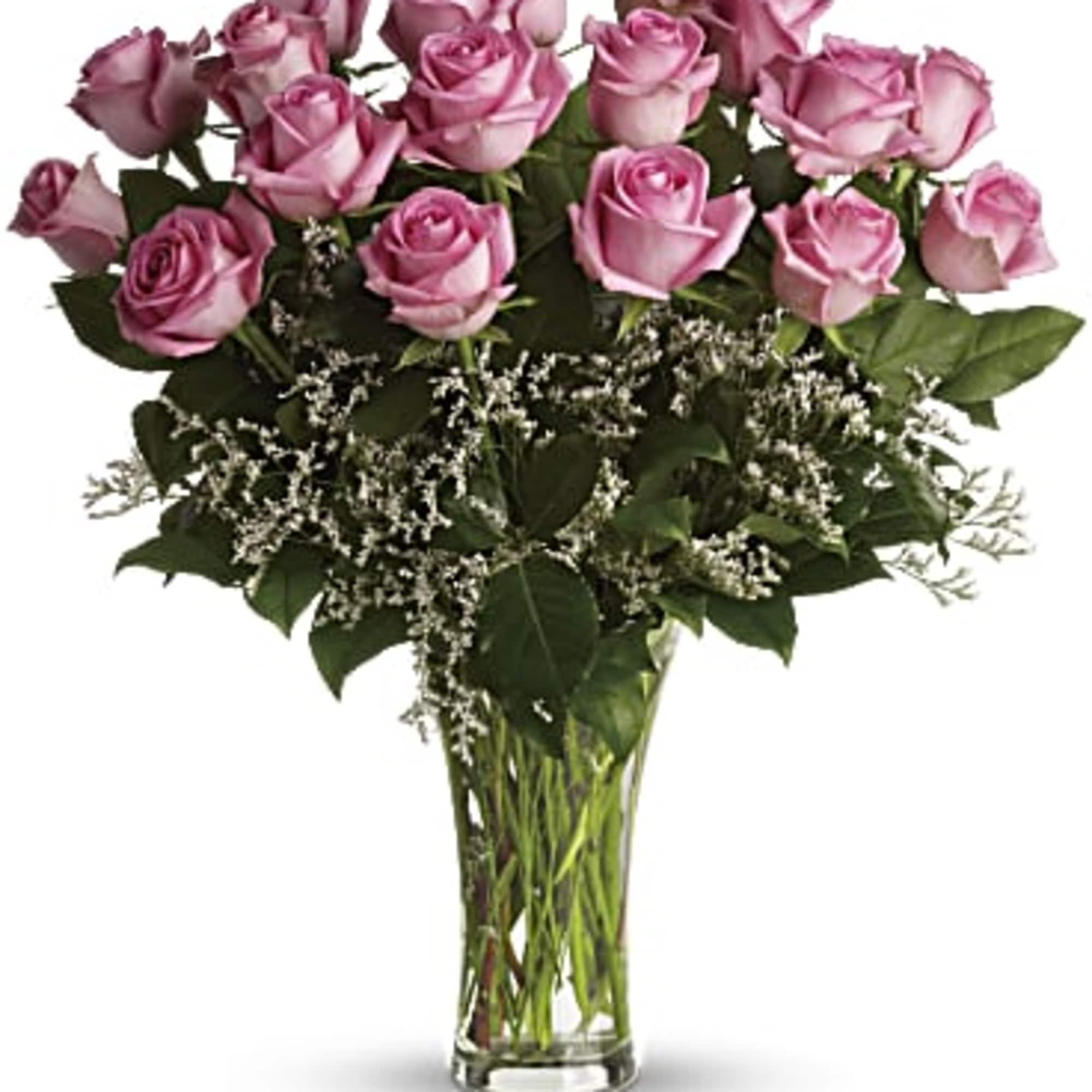 Pink roses arranged in a clear glass vase