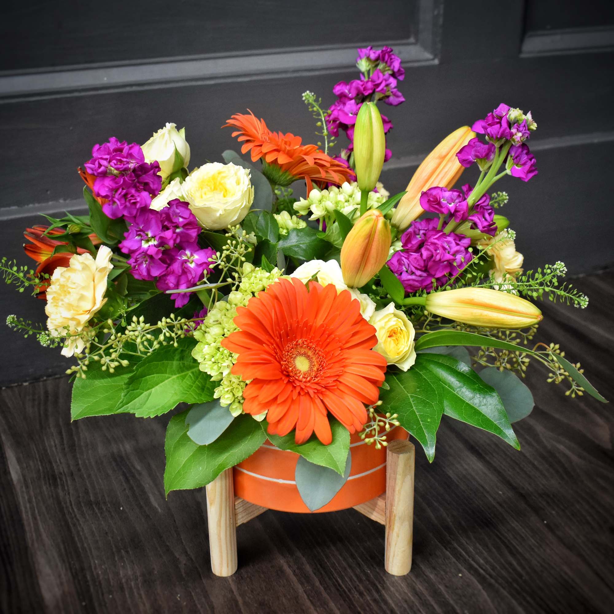 A bold orange gerbera takes center stage in this Sizzlin' Summer Blooms