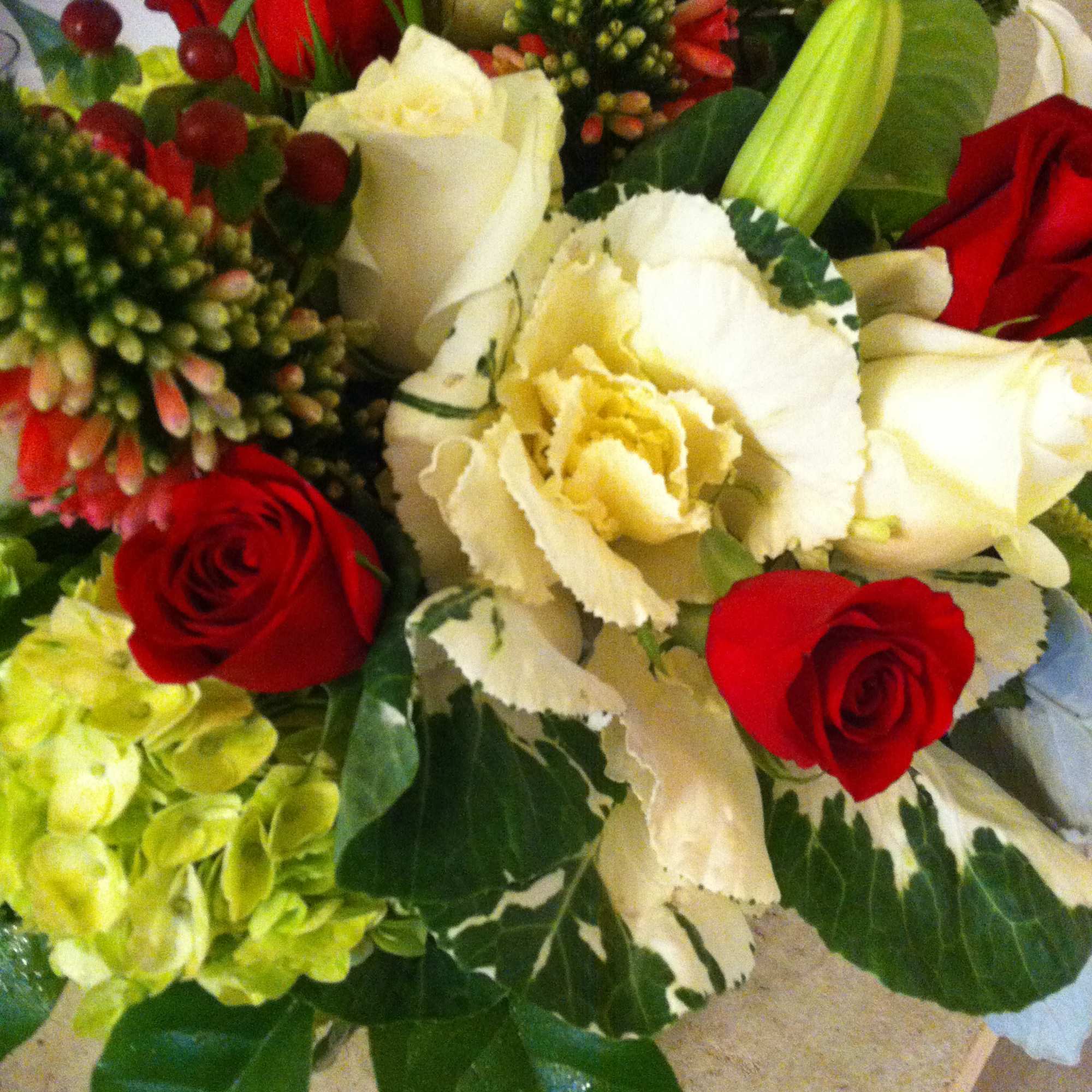 Bouquet of red and white roses with pale green hydrangea and lilies