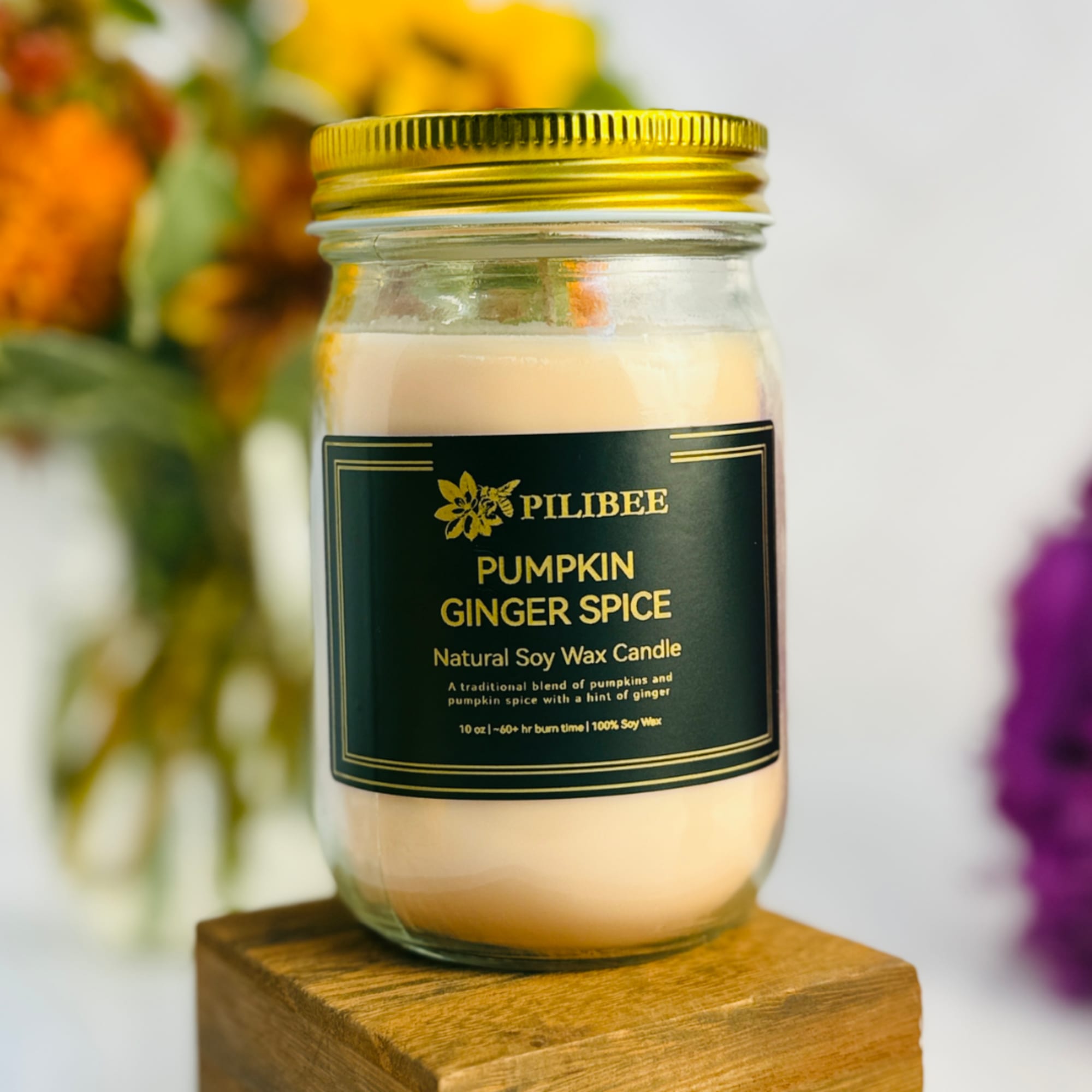 Pumpkin ginger spice candle in a glass jar with a gold lid