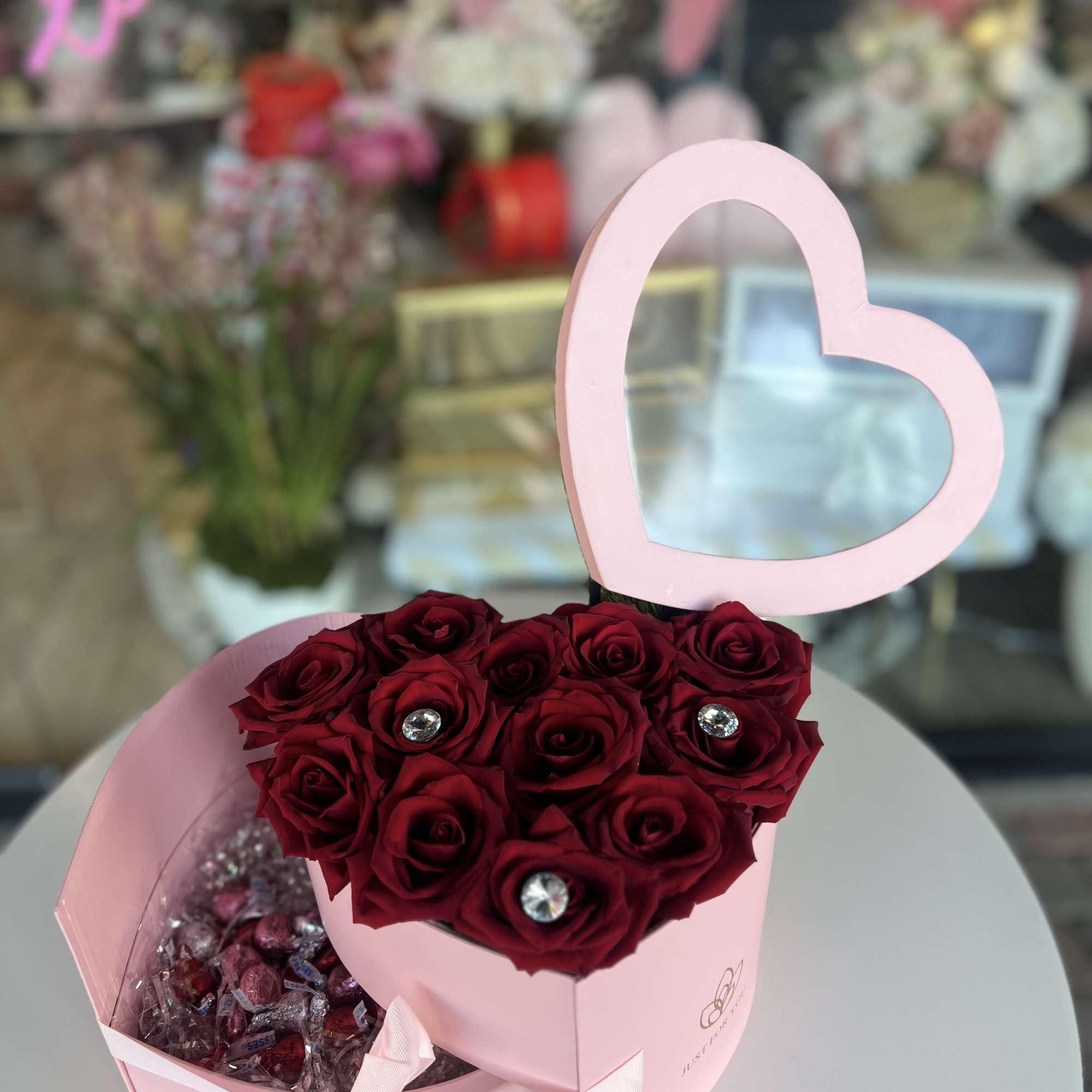 Heart-shaped box with red roses and chocolates